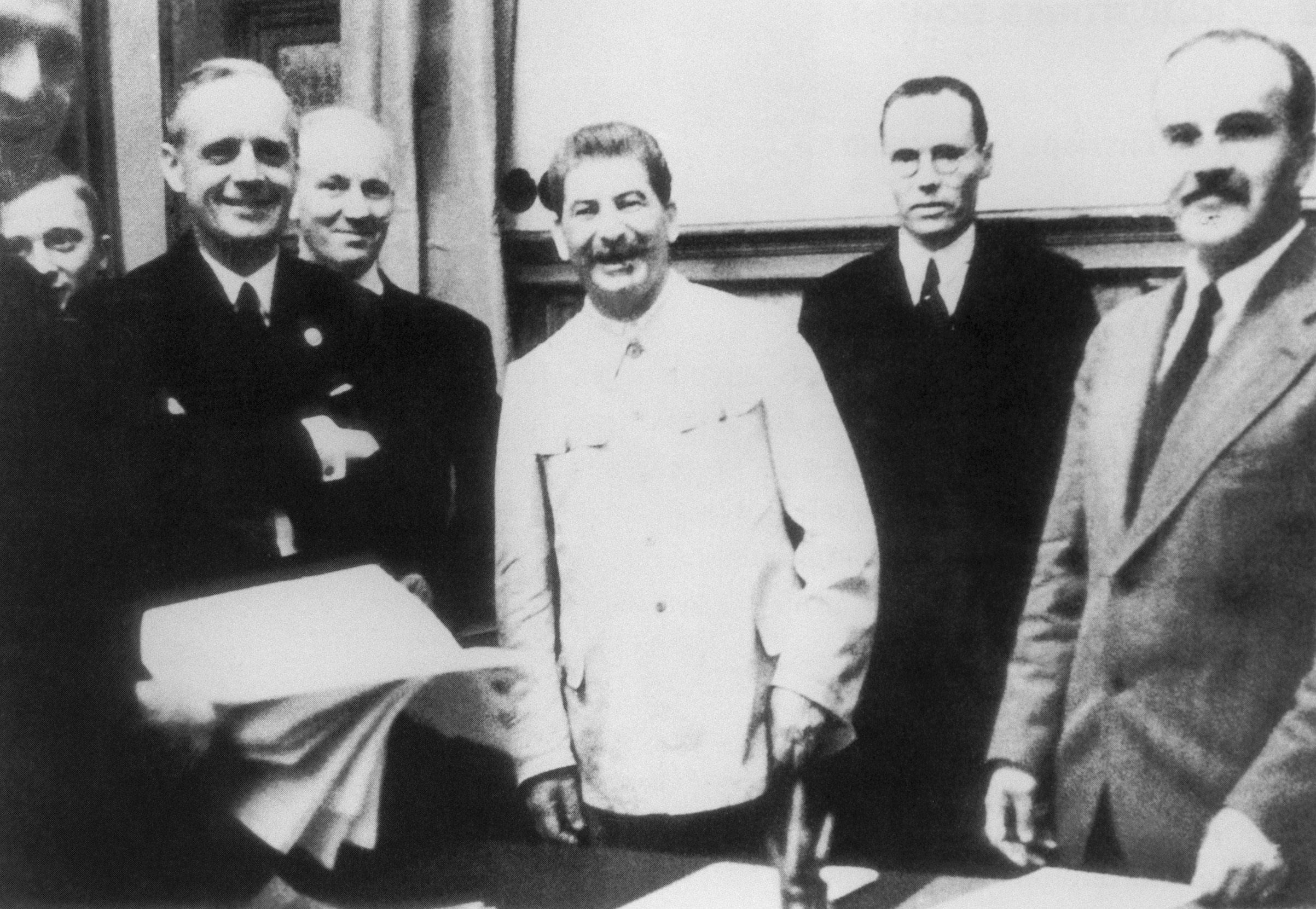 The Foreign Minister of Germany, Joachim von Ribbentrop, Soviet Leader Iosif (Joseph) Stalin and Soviet foreign minister Vyacheslav Molotov (foreground L-R) pose for a photo at the singing ceremony of the German-Soviet Treaty of Nonaggression, Aug. 23, 1939, in Moscow (TASS via Getty Images)