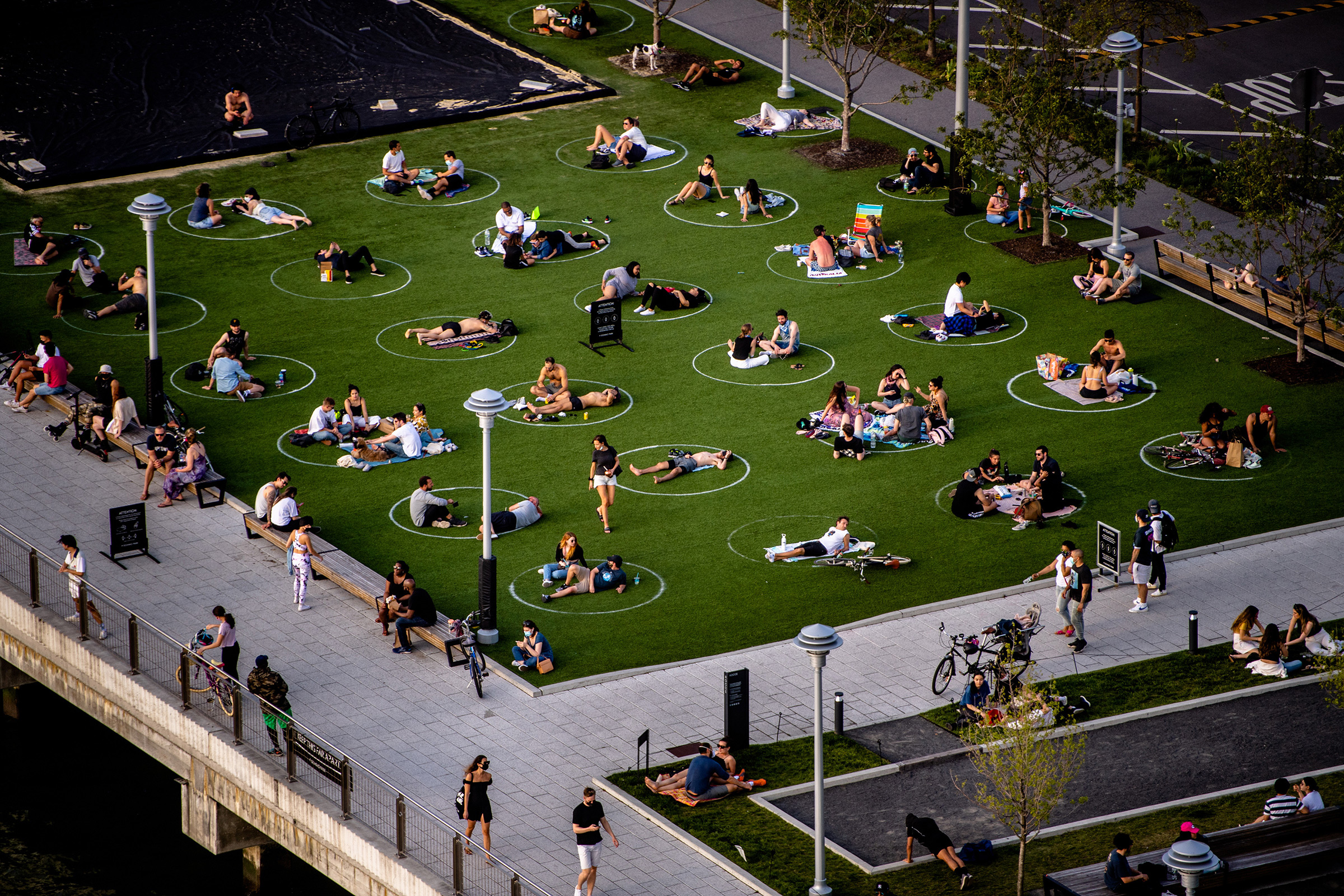 People sit in marked circles to promote social distancing in Brooklyn on May 15, as cities across America adopt new policies to reopen (Hilary Swift—The New York Times/Redux)