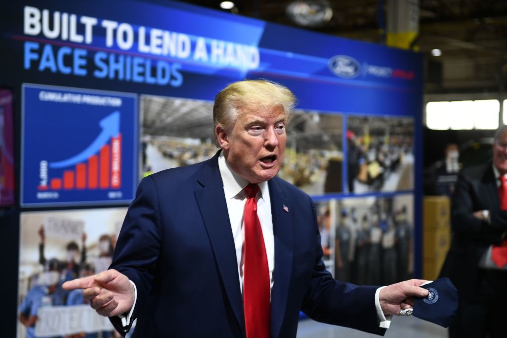 President Donald Trump holds a mask as he speaks during a tour of the Ford Rawsonville Plant in Ypsilanti, Michigan on May 21, 2020. (BRENDAN SMIALOWSKI/AFP—Getty Images)
