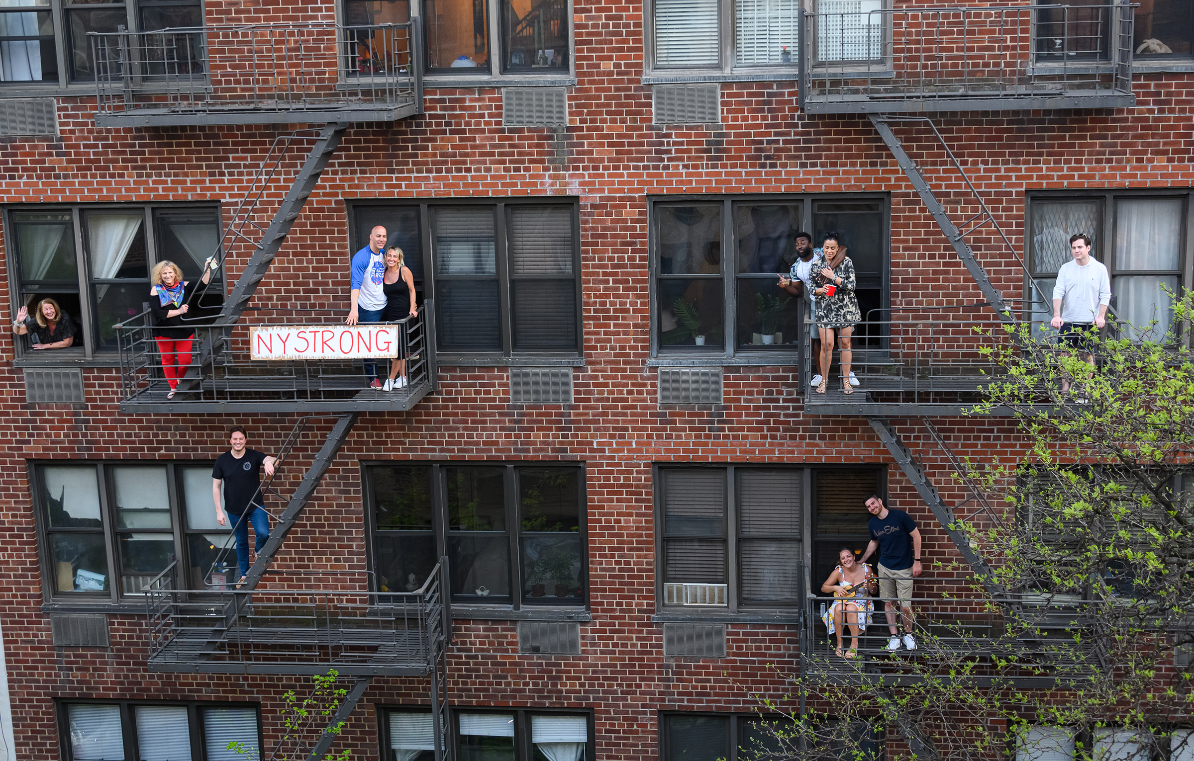 People applaud from their fire escapes to show their gratitude to medical staff and essential workers on the front lines of the coronavirus pandemic during the coronavirus pandemic in the Upper East Side on May 2nd in New York City. (Noam Galai—Getty Images)