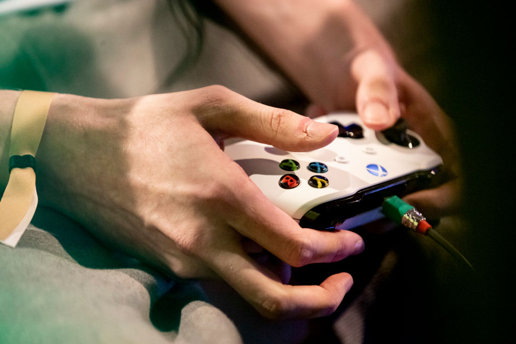 A player's hands can be seen in the "Grand Final" of the Virtual Bundesliga (VBL) with an Xbox controller. (Christoph Soeder — DPA via Getty Images)