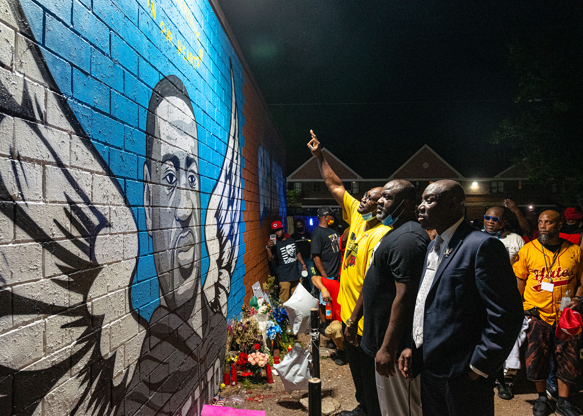 Brothers Rodney and Philonise Floyd visit a memorial and mural that honors their brother George with lawyer, Ben Crump in Houston's Third Ward where Mr. Floyd grew up, on June 8. (Ruddy Roye for TIME)