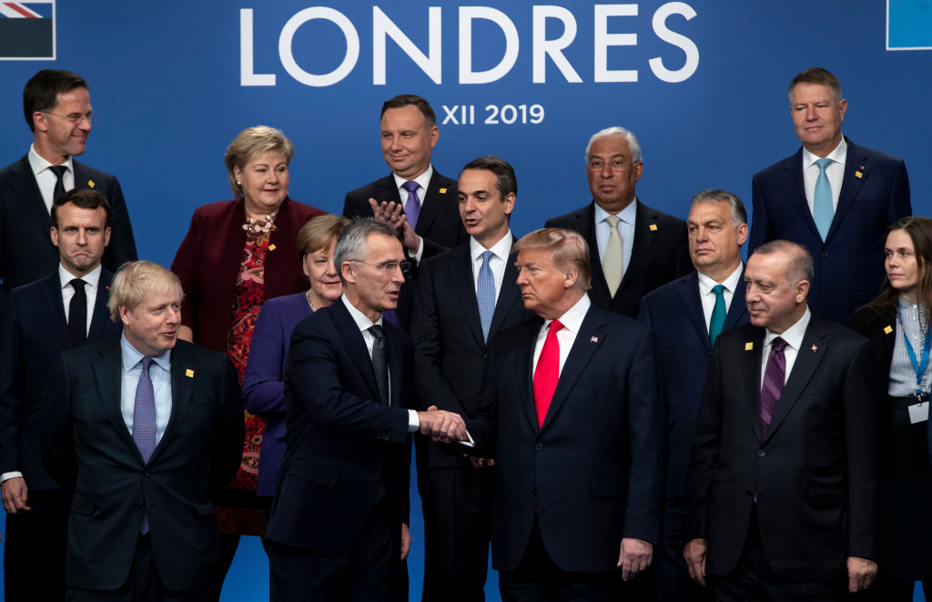 NATO Secretary General Jens Stoltenberg shakes hands with U.S. President Donald Trump during a group photo at NATO North Atlantic Treaty Organisation Summit in London on Dec. 4, 2019. (Xinhua/Han Yan— Getty Images)