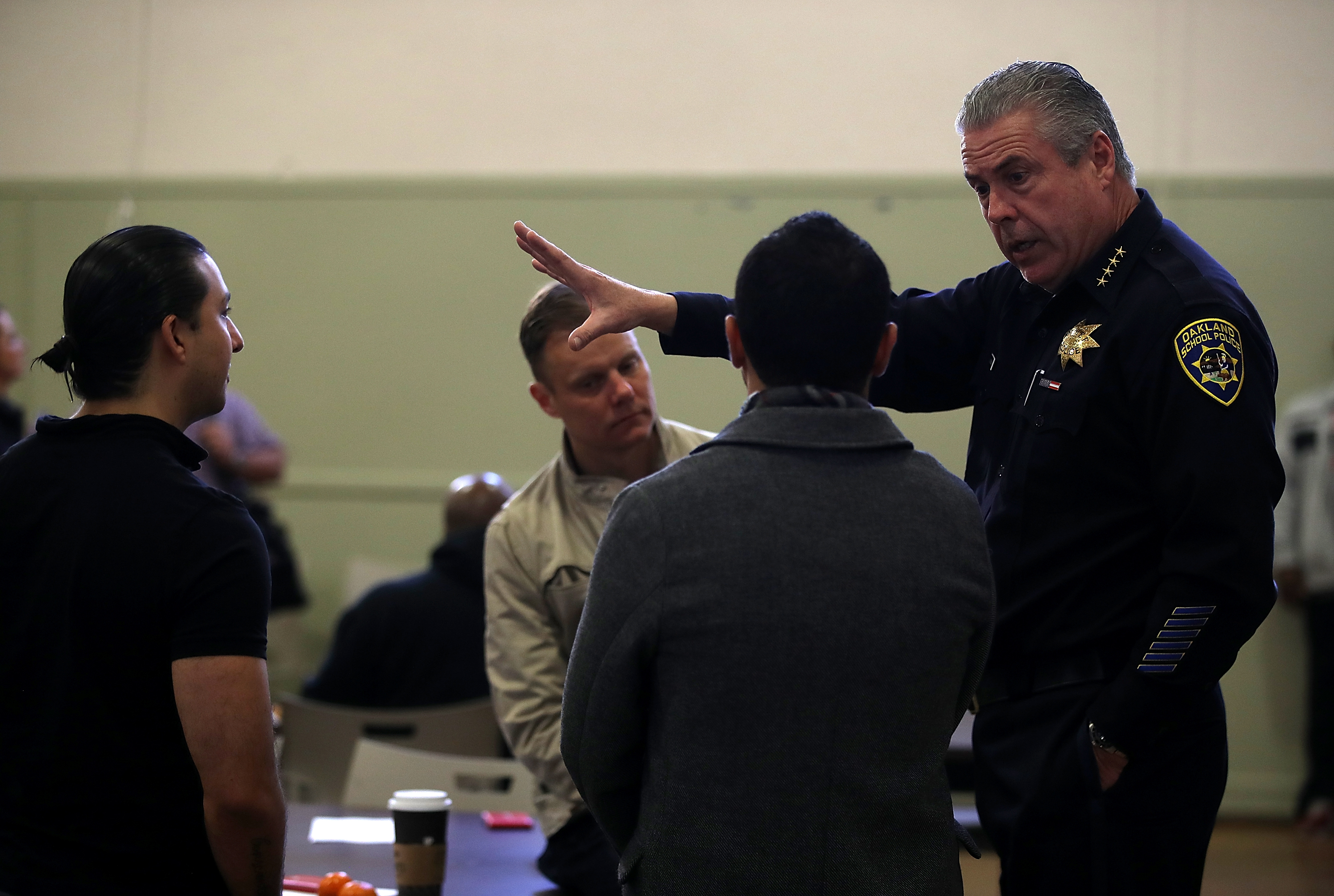 Oakland Schools Police chief Jeff Godown (R) speaks to school staff during an active shooter training session on Feb. 16, 2018 in Oakland, Calif. Godown supported the school district's decision to disband the police force, even though it could end his job. (Justin Sullivan—Getty Images)