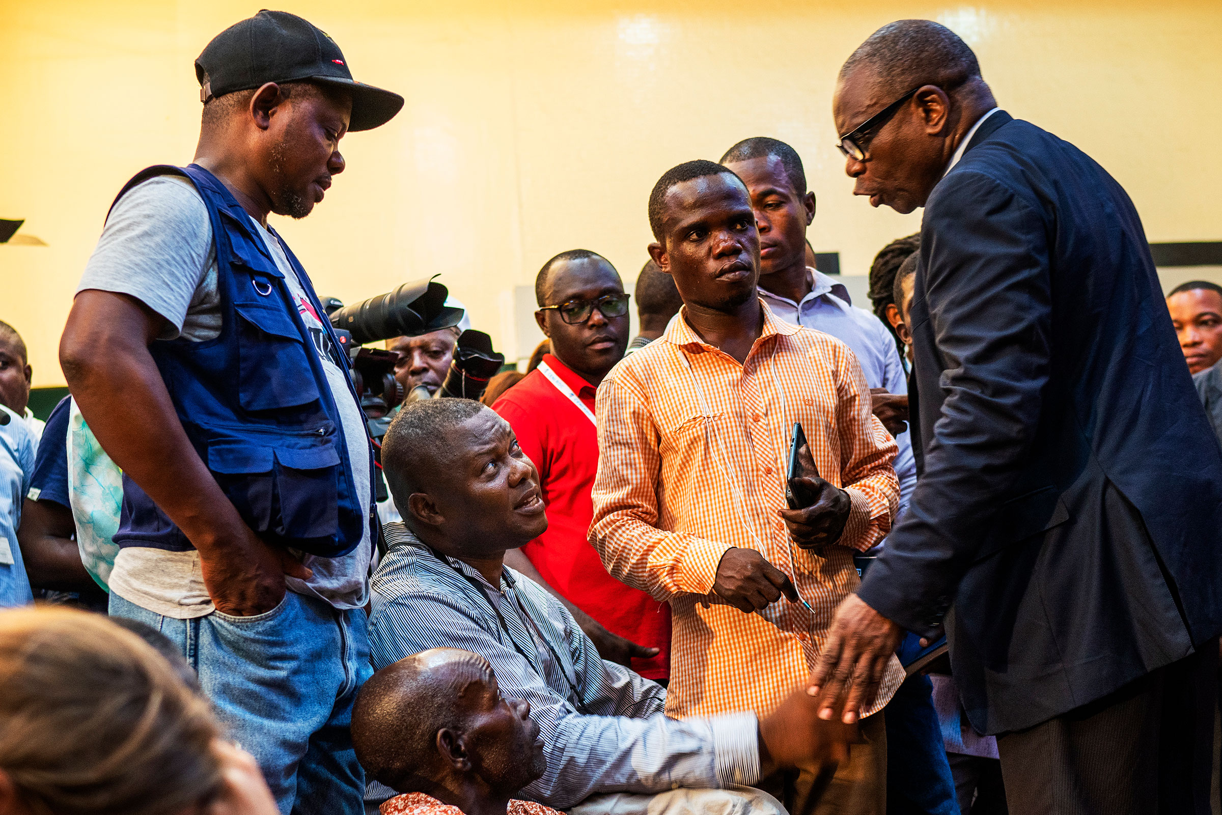 AP contributing photographer John Bompengo, center, during a press conference in Kinshasa, Democratic Republic of Congo on Dec. 20 2018. (Jerome Delay—AP)