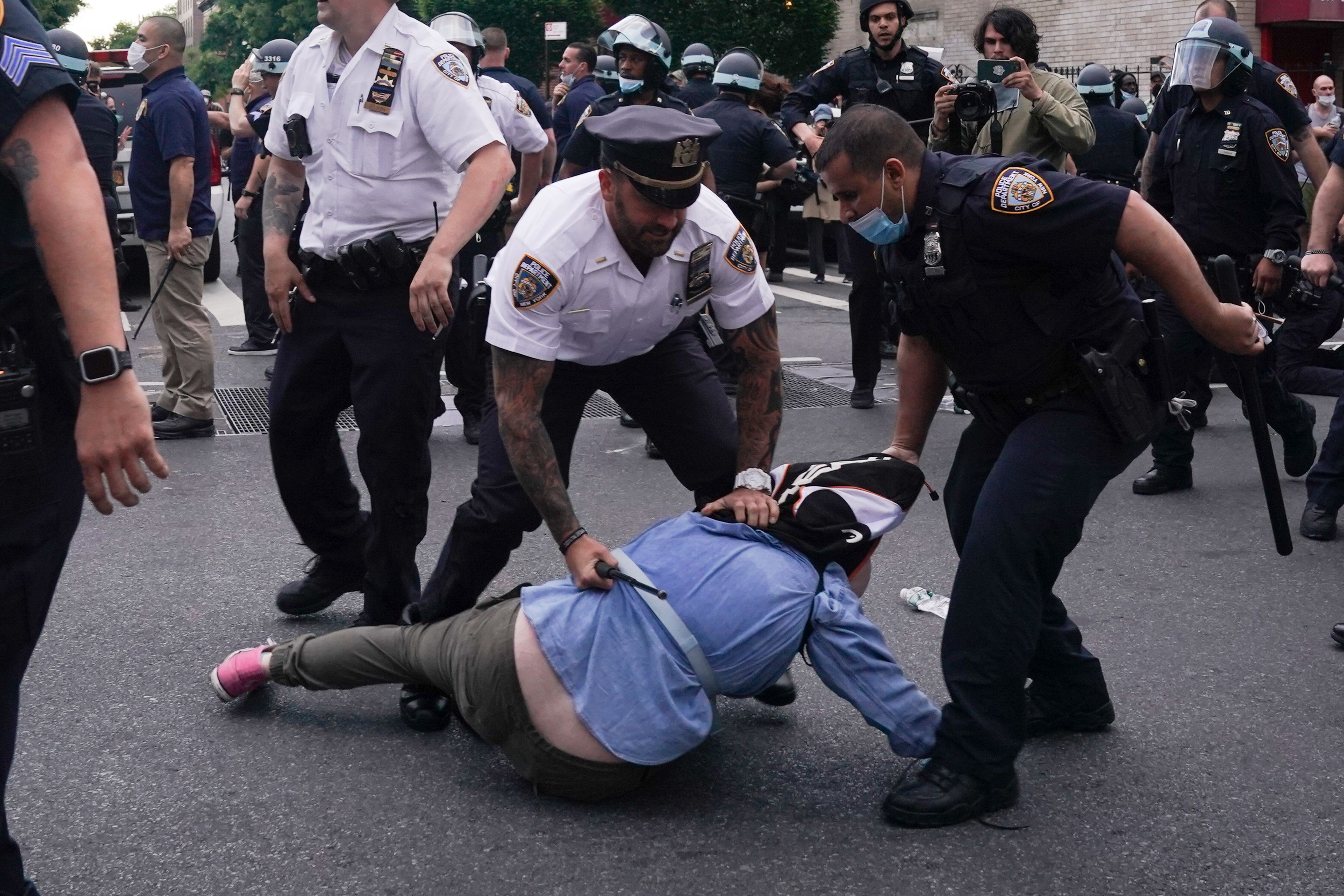 NYPD officers arrest protesters during a demonstration against the killing of George Floyd by Minneapolis police on May 30, 2020 in Brooklyn.74