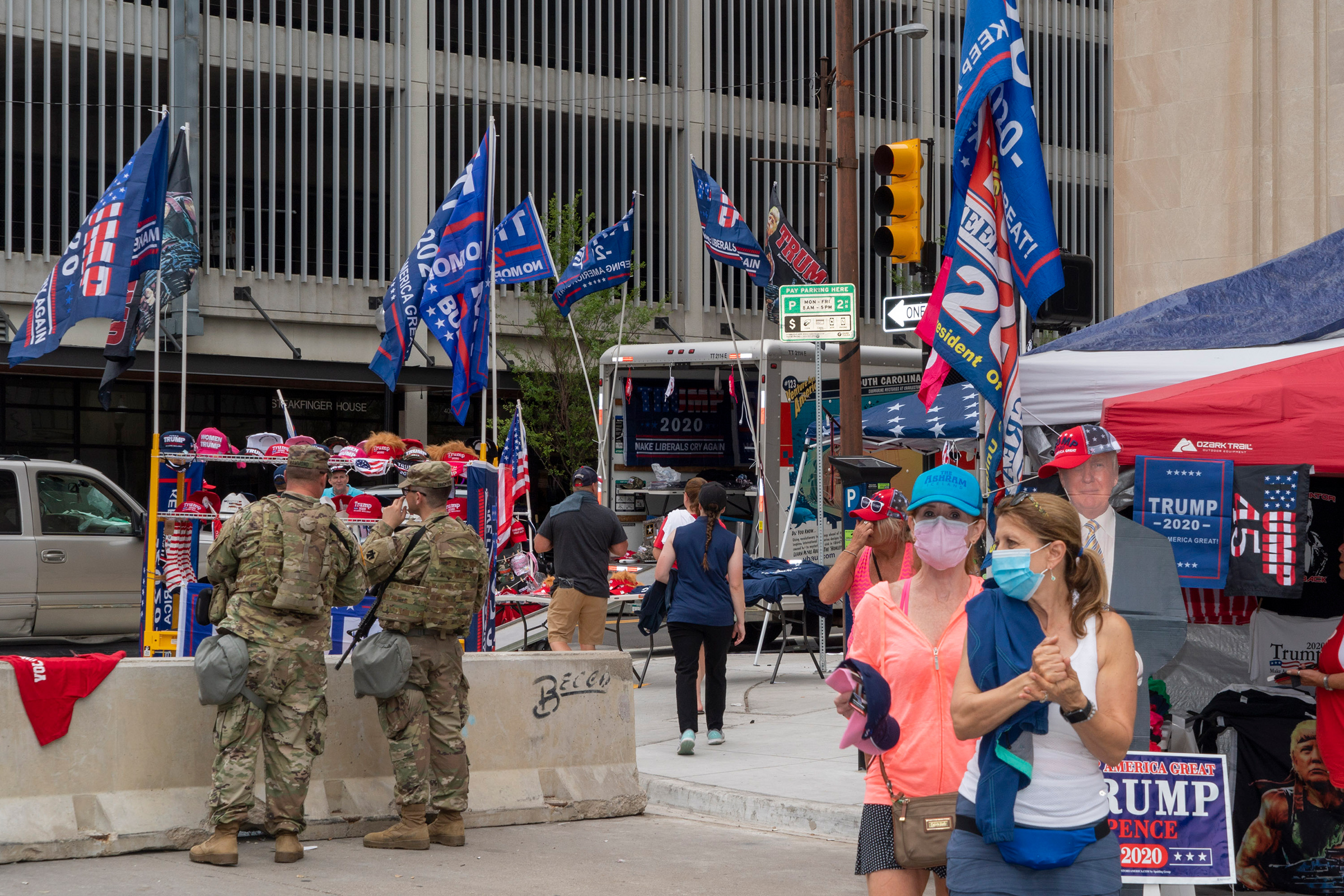 2020. Tulsa, Oklahoma. USA. National Guard and vendors selling Trump memorabilia near an entrance to the Trump rally.
