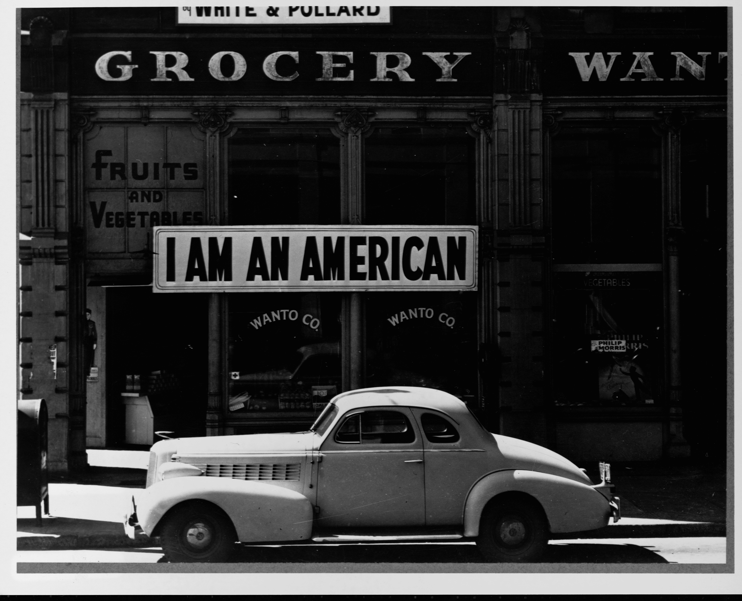 The Japanese owner of this grocery store in Oakland, California displays a sign reminding pedestrians of his loyalties to America, and not Japan, in 1944.