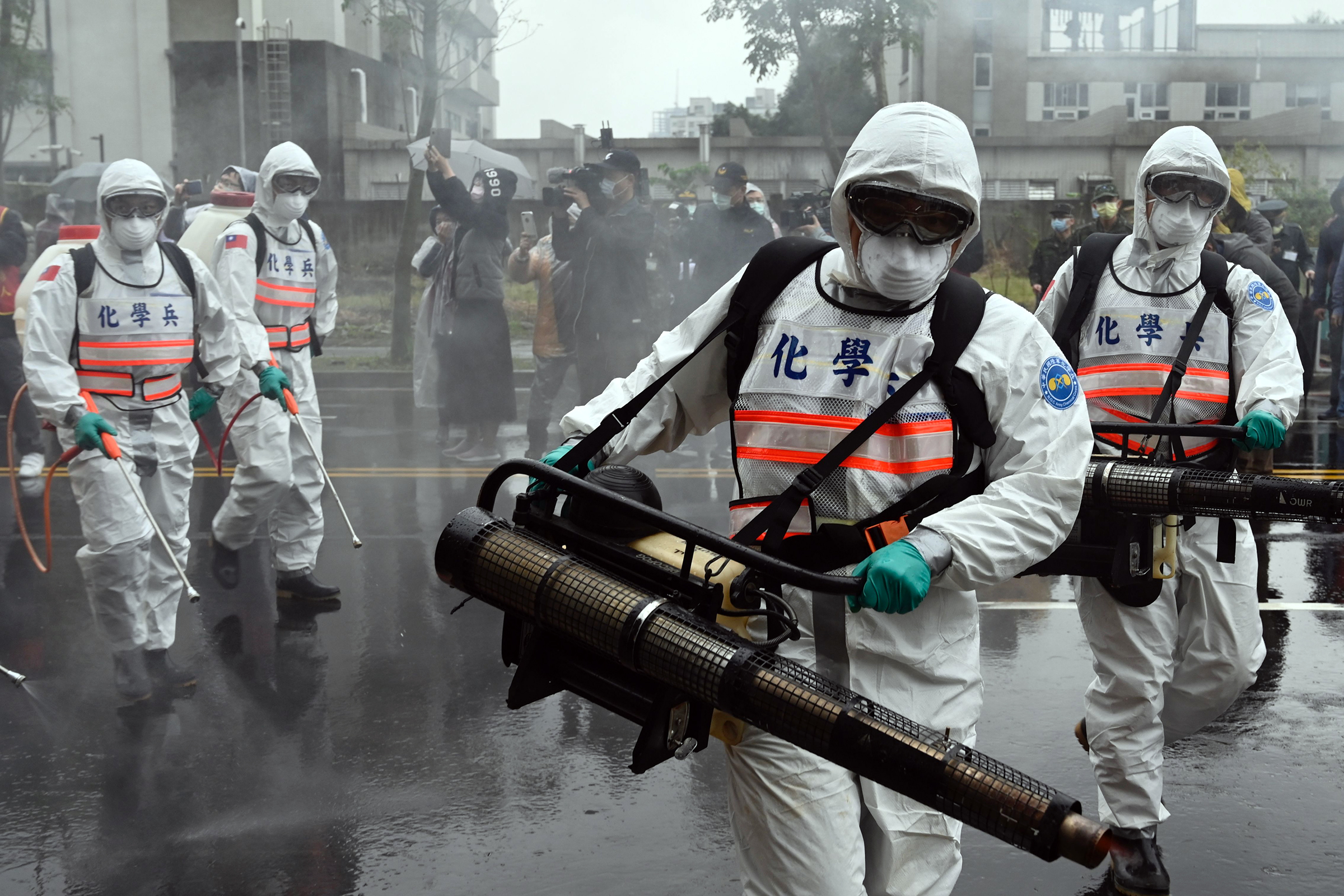 Soldiers from the military's chemical units take part in a drill to prevent the spread of the COVID-19 coronavirus, in Xindian district in Taiwan on March 14, 2020. (Sam Yeh—AFP via Getty Images)