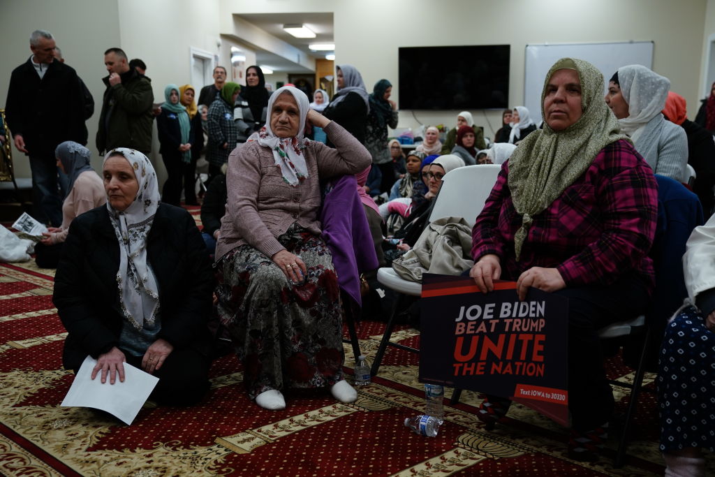 A participant holds a campaign sign for former U.S. Vice President Joe Biden, 2020 Democratic presidential candidate, during the first-in-the-nation Iowa caucus at the Islamic and Education Center Ezan mosque in Des Moines, Iowa, on Feb. 3, 2020. (Elijah Nouvelage—Bloomberg/Getty Images)