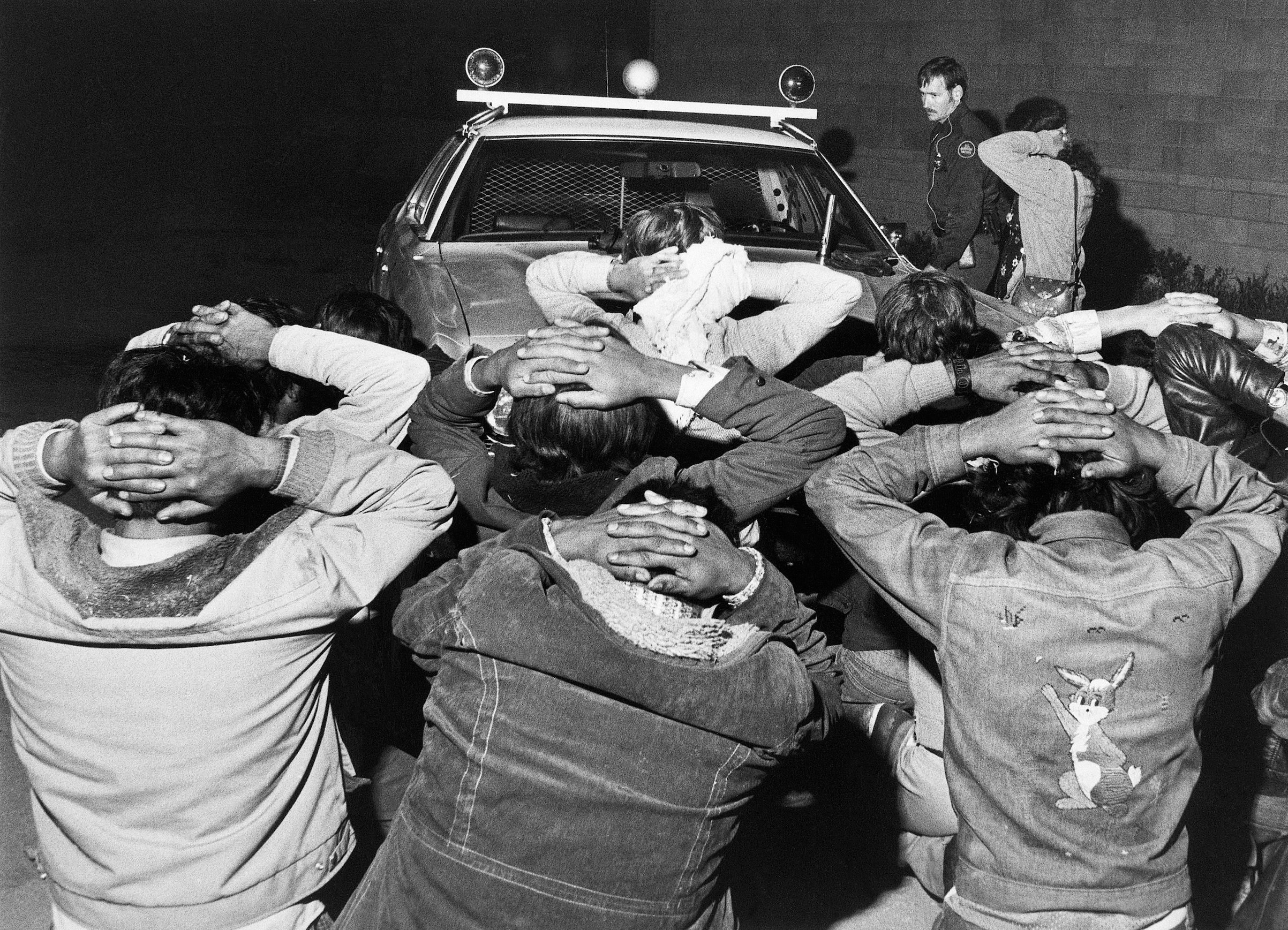 Men who have been caught trying to cross the border from Mexico to the United States, in Tijuana, Mexico, on May 11, 1977. (Bettmann Archive)