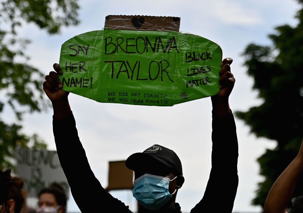 Protesters hold up signs on June 3, 2020, during a 