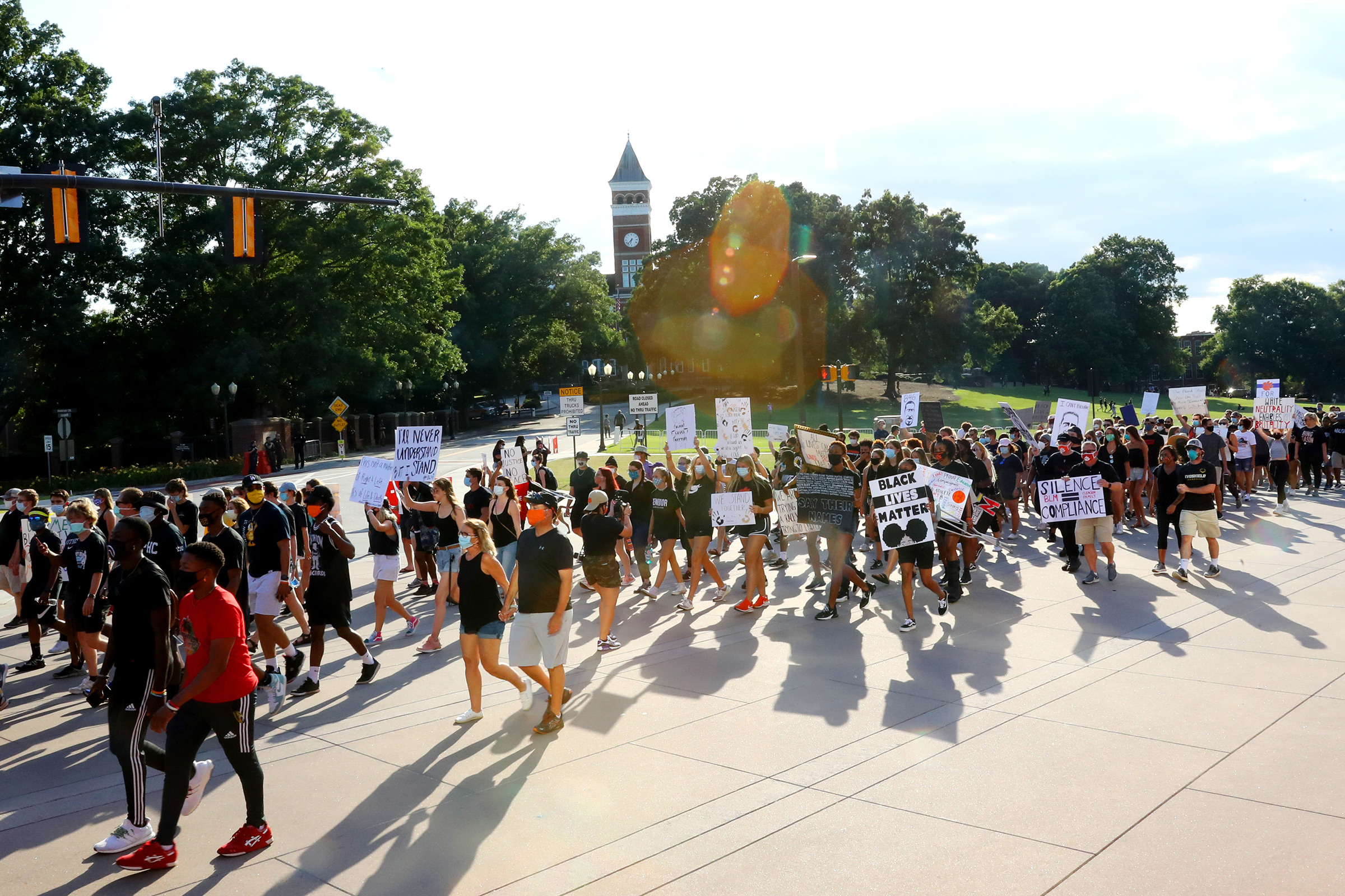 Clemson University football players lead a "March for Change" protest past Tillman Hall on June 13 in Clemson, South Carolina. The Clemson University Board of Trustees voted to strip "Calhoun" from their Honors College name and rename Tillman Hall. (Maddie Meyer—Getty Images)
