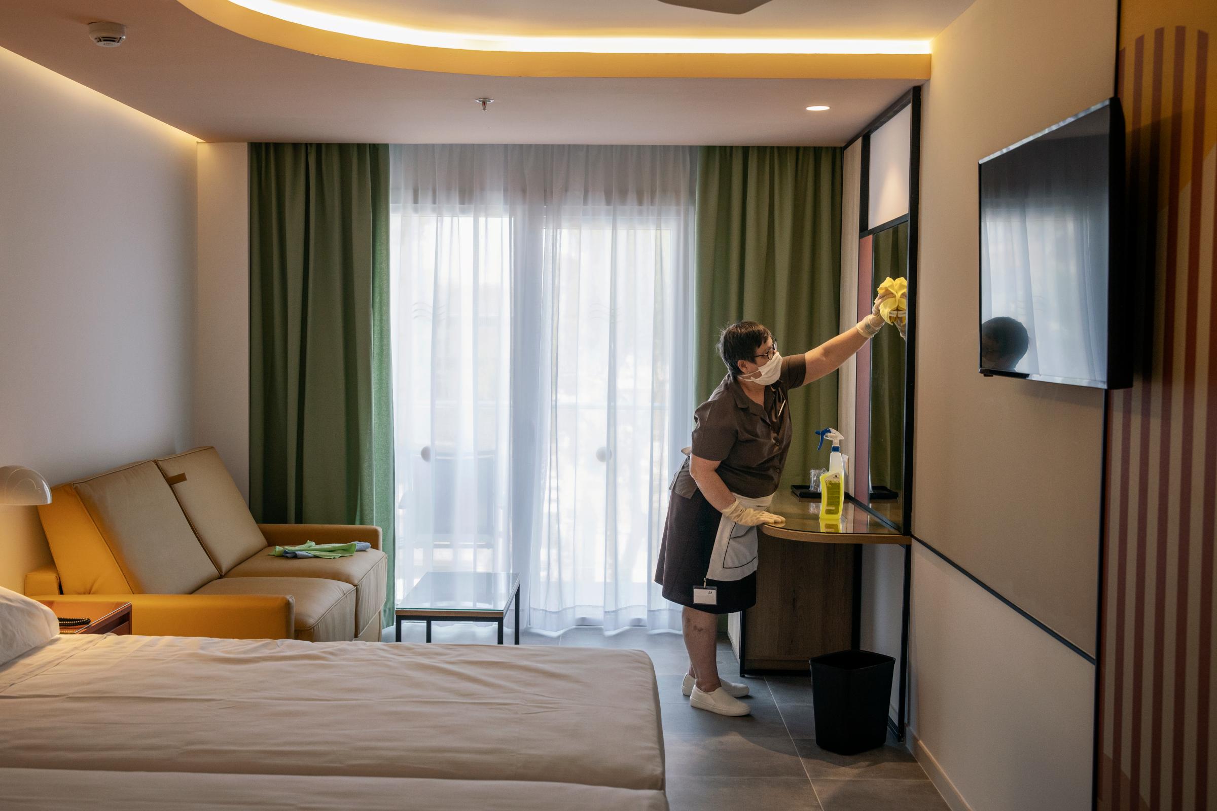 Playa de Palma, Mallorca, a member of the Riu Concordia Hotel staff at work cleaning and disinfecting a room.
