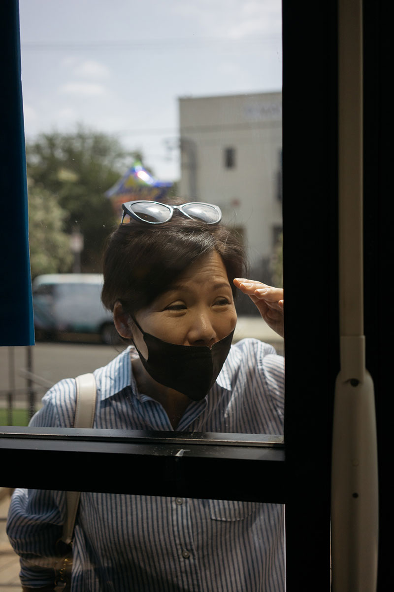 Lydia Yang visits her father, Noh Park, through the front window.