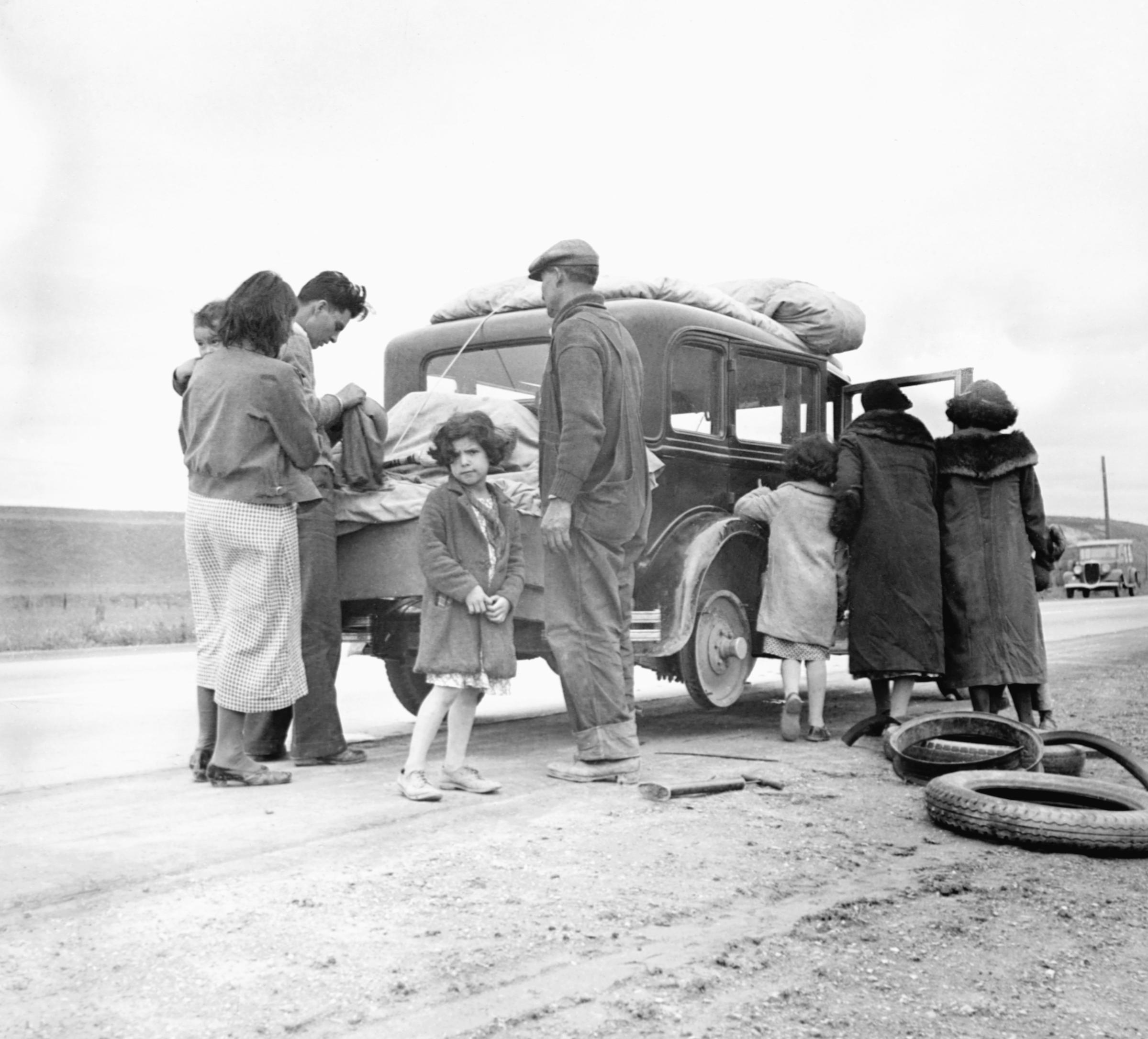 Migrant Family Changing Tire