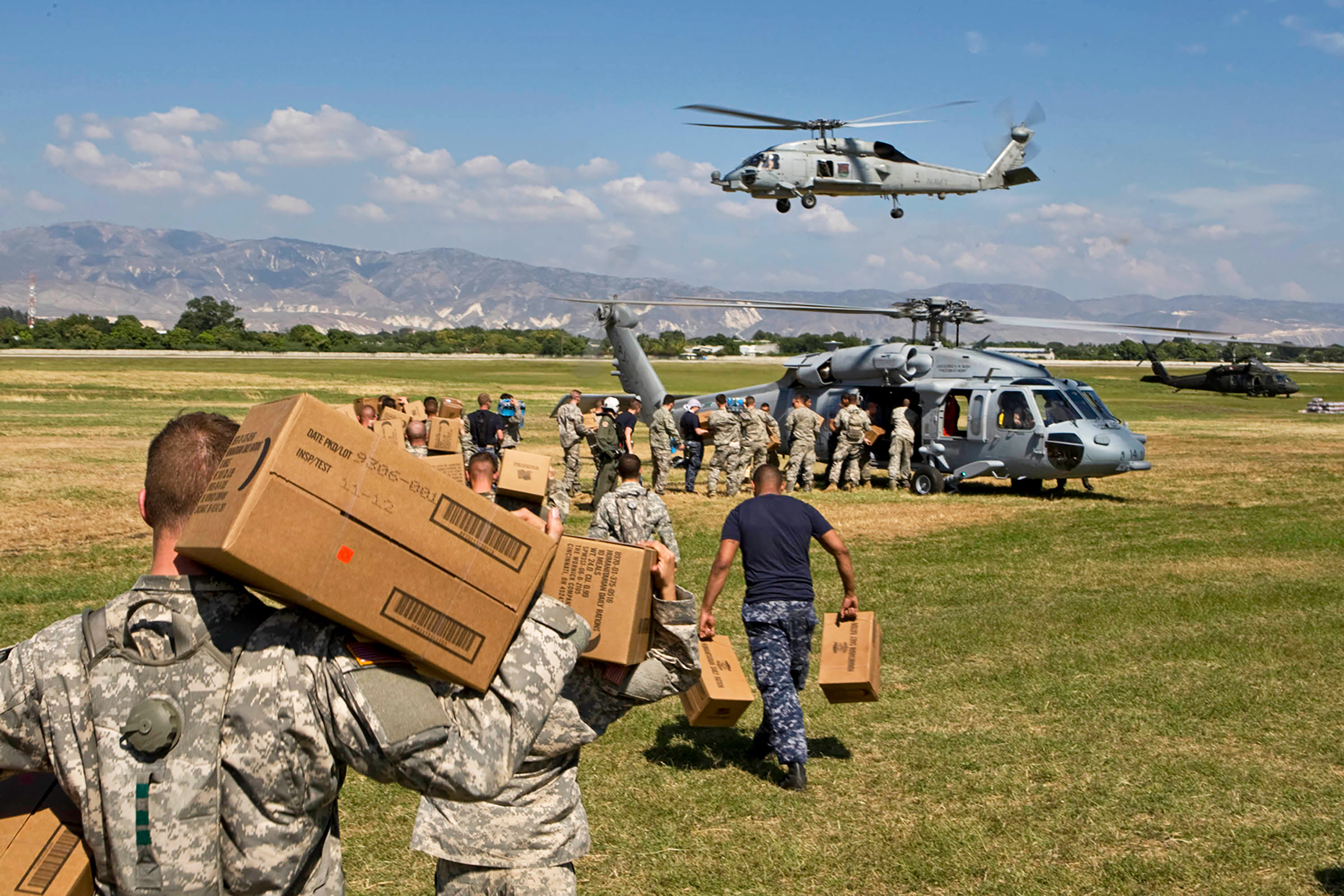 U.S. soldiers load aid onto a helicopter in January 2010 in Port-au-Prince, Haiti, after a devastating earthquake (Logan Abassi—MINUSTAH/Getty Images)