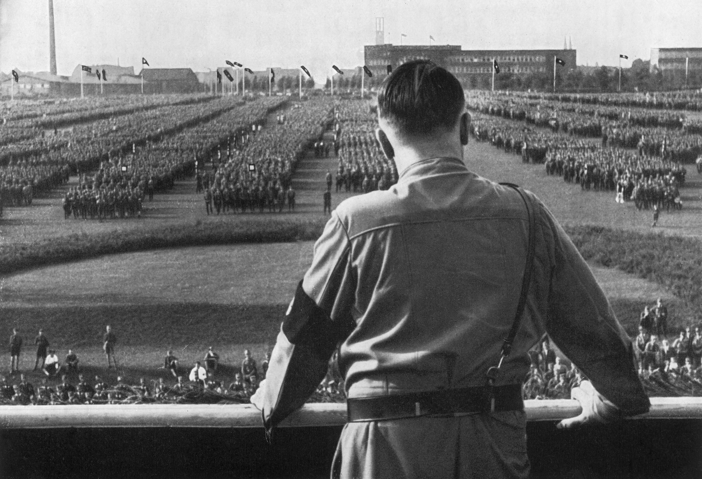 Nazi leader Adolf Hitler addresses soldiers with his back facing the camera at a Nazi rally in Dortmund, Germany, in 1933. (Getty Images)