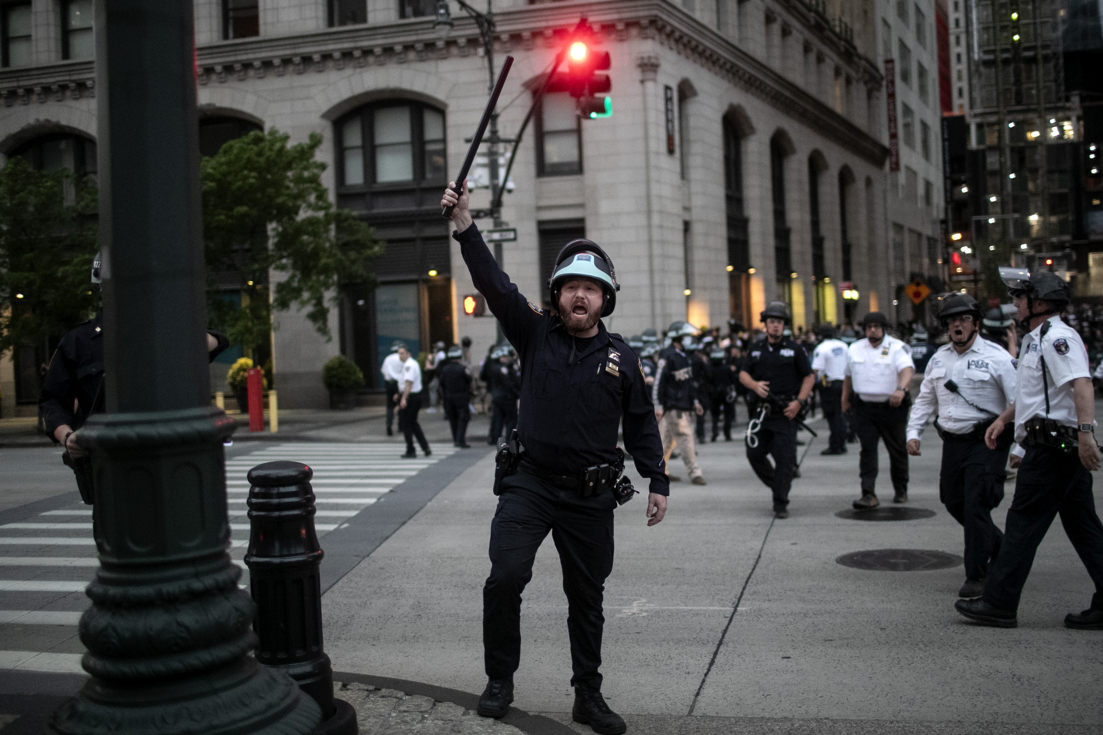 Police look for people who did not get off the street after the start of curfew on June 2, 2020, in New York.