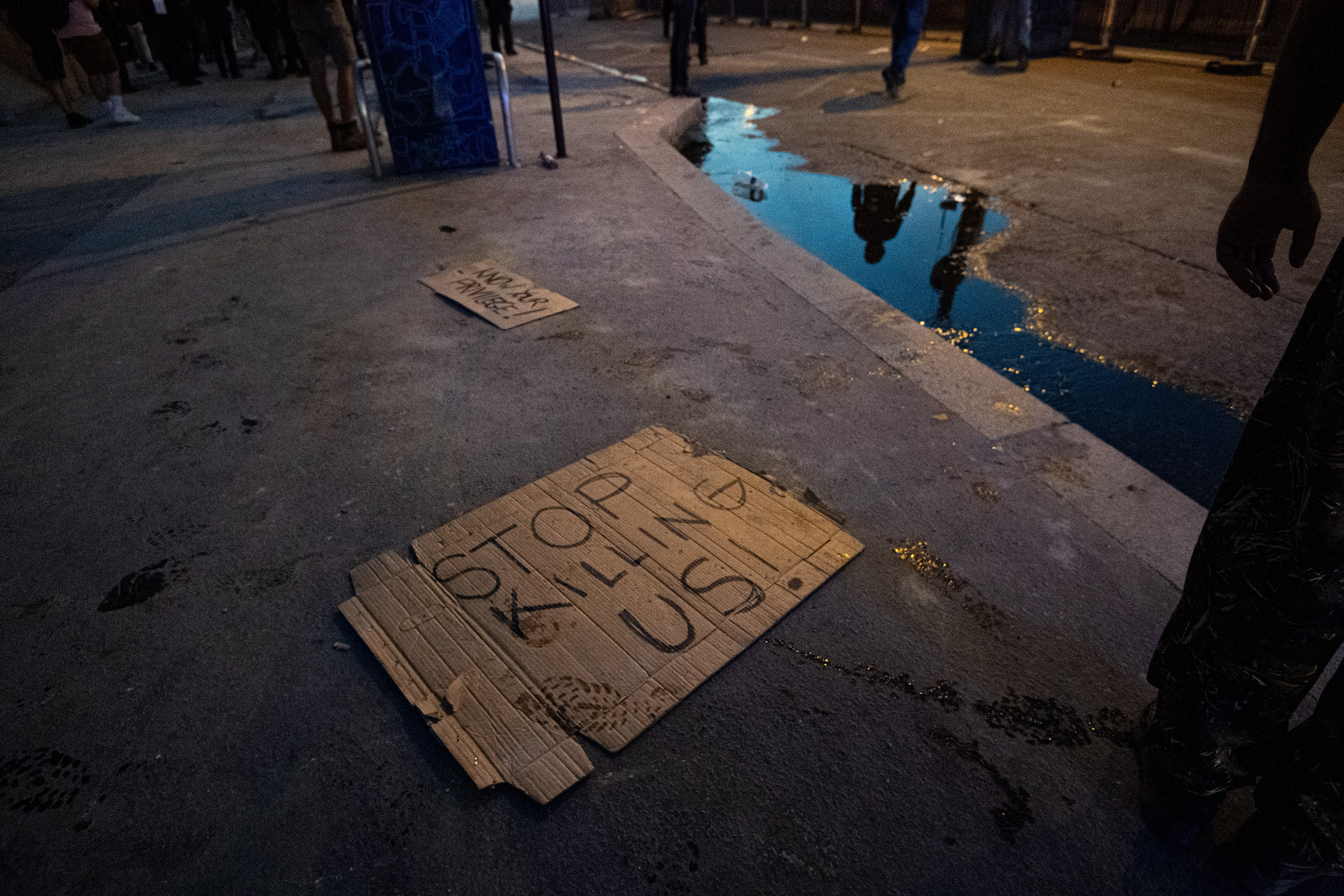 Signs are seen on the floor after clashes erupt following the intervention of security forces in a protest against police brutality at the Tribunal de Paris courthouse on June 2. (Julien Benjamin Guillaume Mattia—Anadolu Agency/Getty Images)