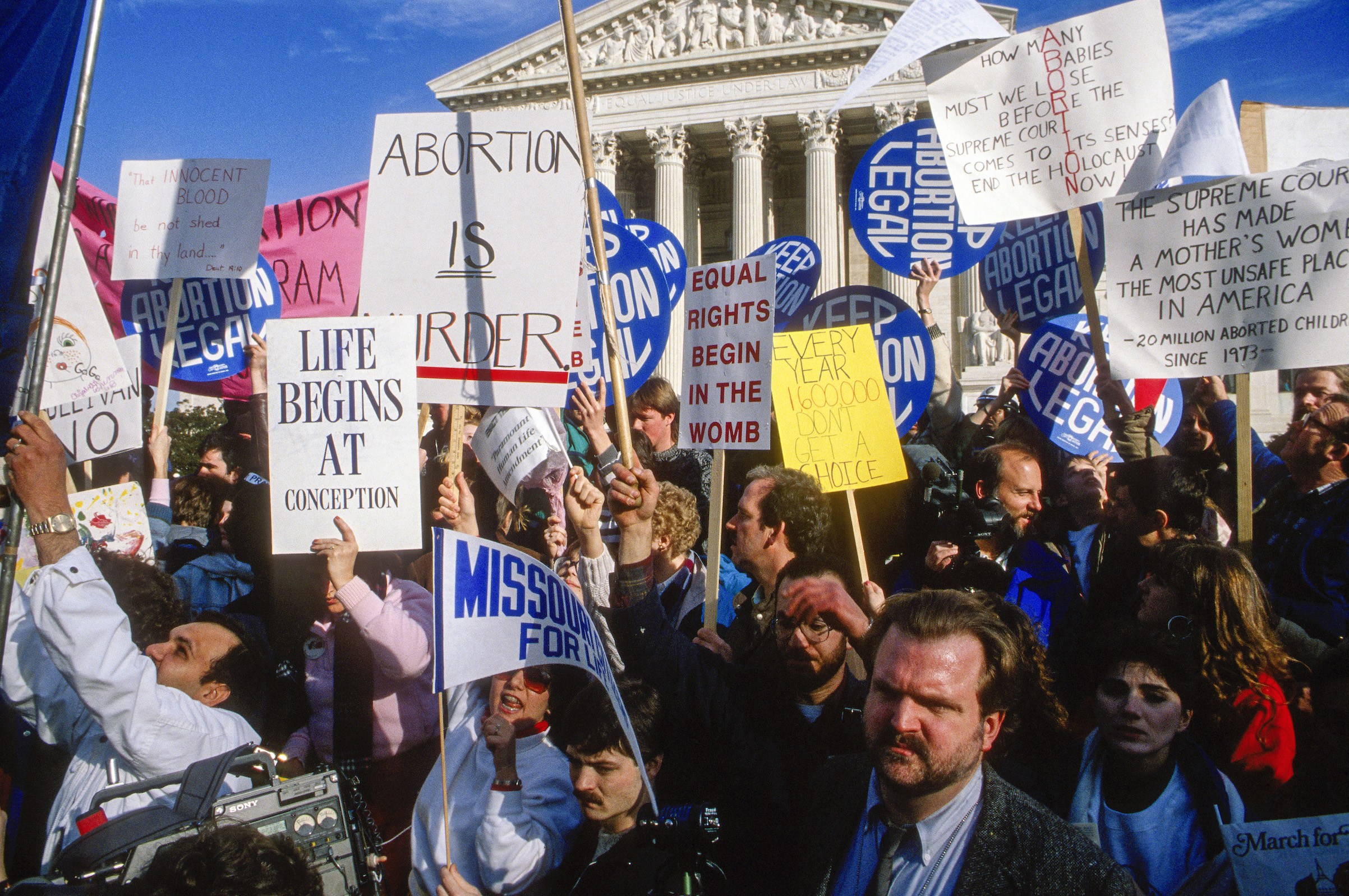 Anti-abortion and abortion-rights demonstrators both wave their signs outside the United States Supreme Court Building in Washington, D.C., on Jan. 22, 1989. (Mark Reinstein—Corbis / Getty Images)