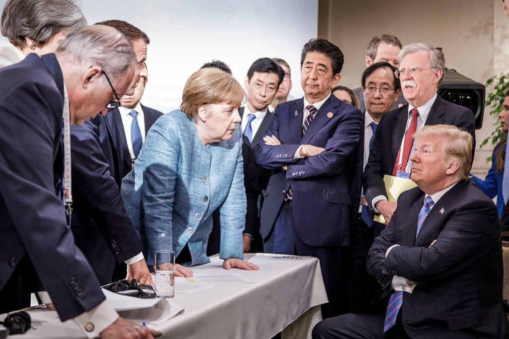 German Chancellor Angela Merkel deliberates with US president Donald Trump at the G7 summit on June 9, 2018 in Charlevoix, Canada. (Jesco Denzel /Bundesregierung via Getty Images&mdash;2018 BPA)