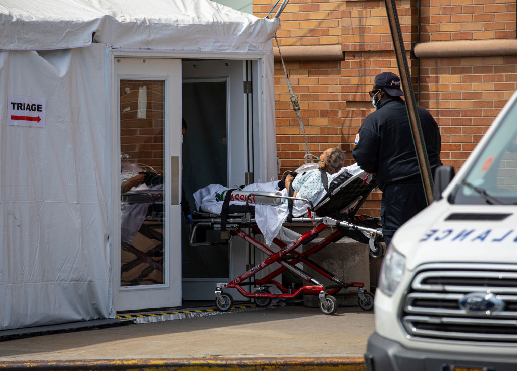 A private ambulance team brings in a probable COVID-19 patient to a triage room outside the Maimonides Medical Center in New York City on April 7, 2020. (Getty Images&mdash;2020 Robert Nickelsberg)