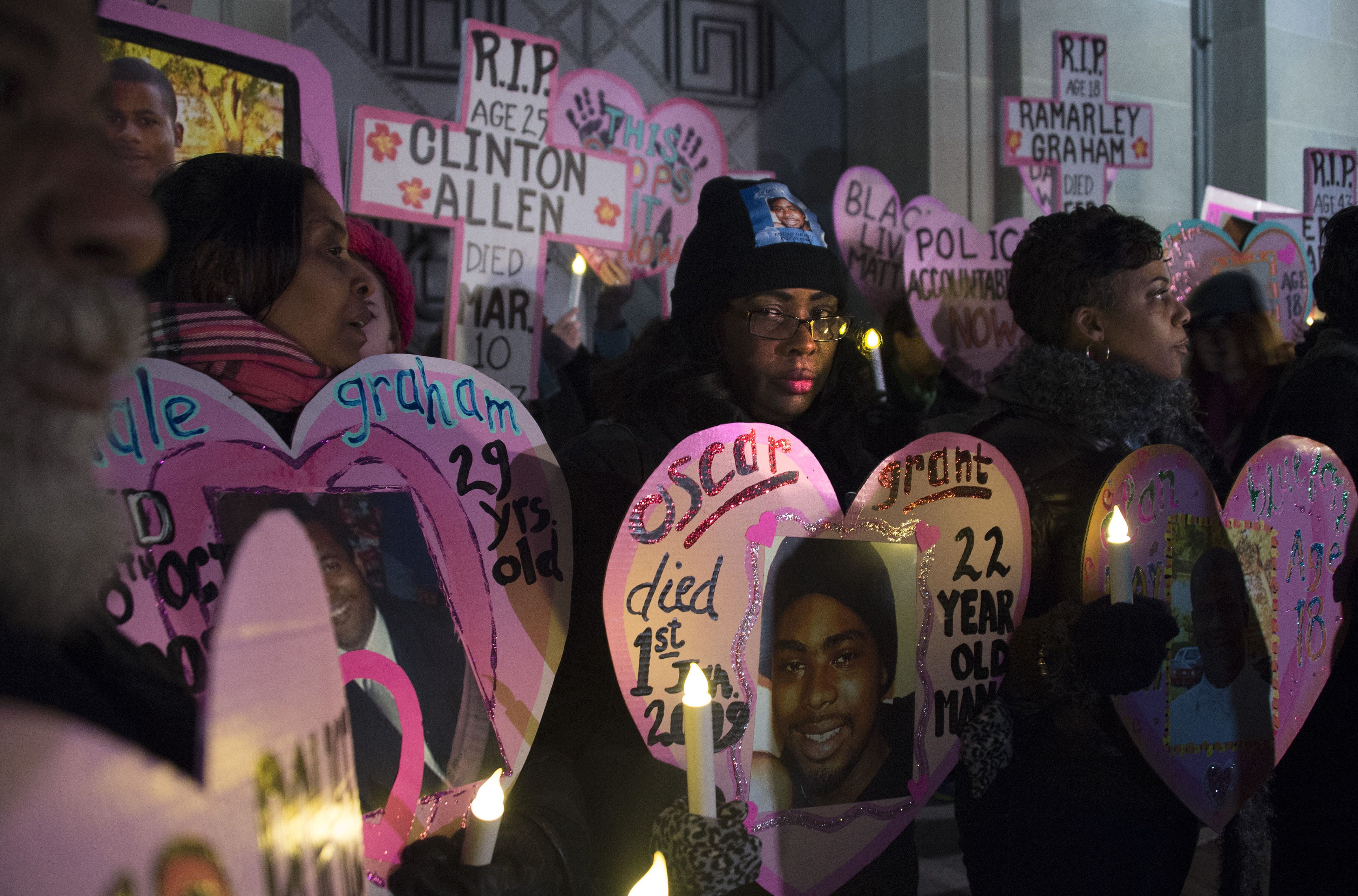 Wanda Johnson (center), whose son Oscar Grant was fatally shot in 2009 by a police officer in Oakland, California, stands with others during a vigil in Washington, D.C., on Dec. 10, 2014. (Jim Watson/AFP—Getty Images)