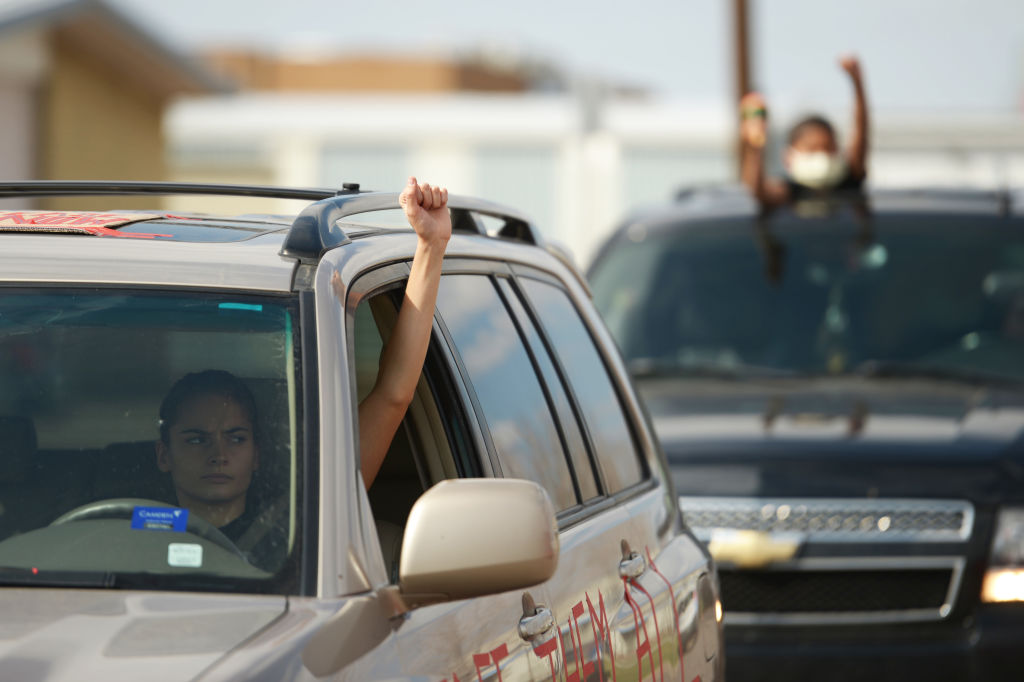 Protesters participate in a car caravan to increase the pressure on ICE to release GEO detainees in front of GEO Aurora ICE Processing Center in Aurora, Colorado. April 9, 2020. (Photo by Hyoung Chang/MediaNews Group/The Denver Post via Getty Images)