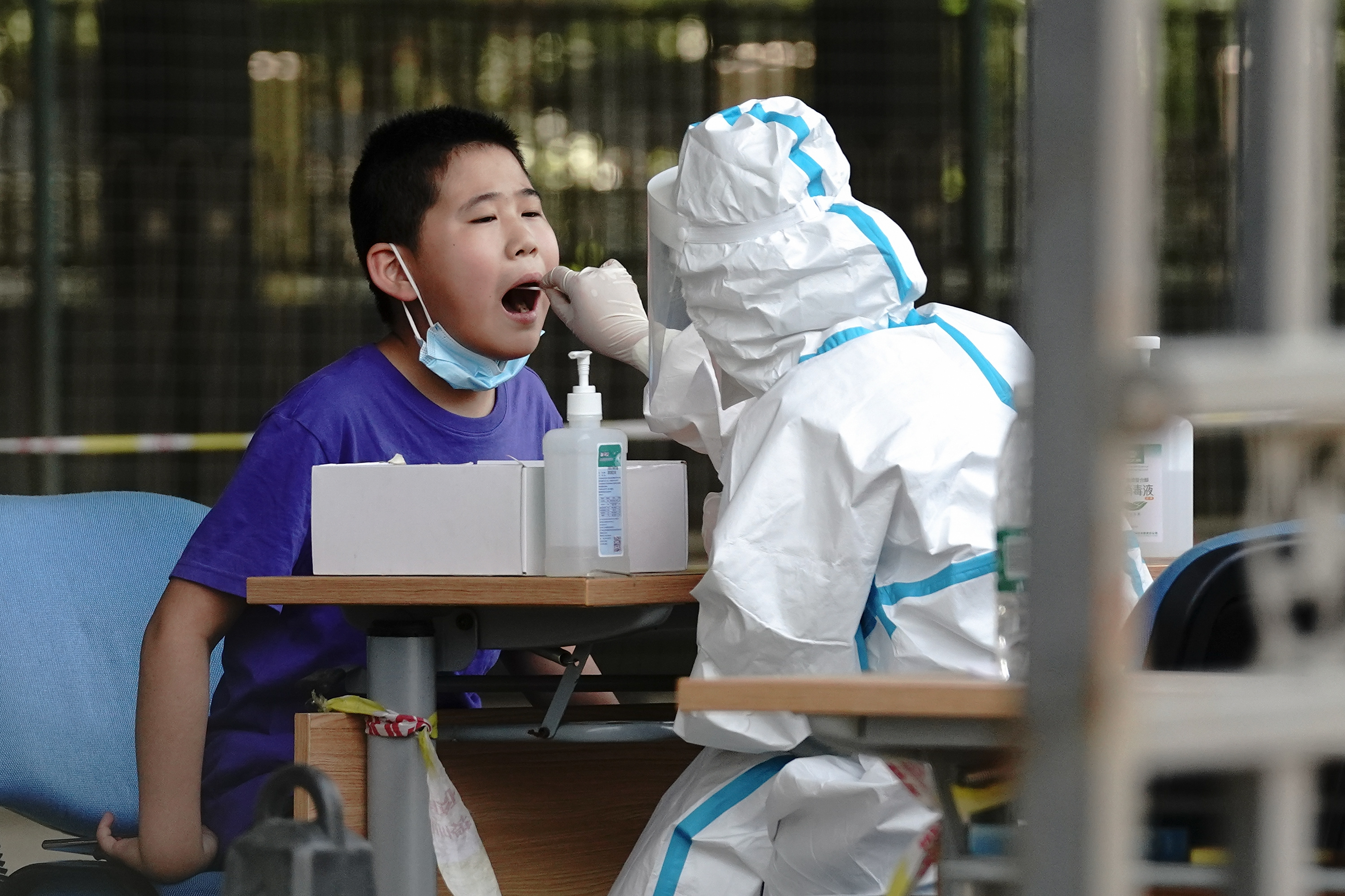 A medical worker wearing a protective suit takes a swap at a temporary COVID-19 testing site on June 30, 2020 in Beijing, China. (Lintao Zhang/Getty Images)