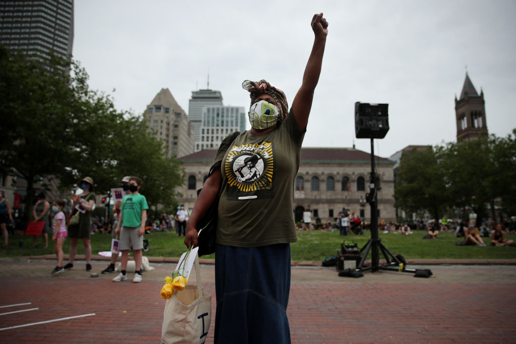 Janice Thomas, a mother of four, raises her fist during the March Like A Mother for Black Lives rally in Boston in June. (Craig F. Walker / The Boston Globe—Getty Images)