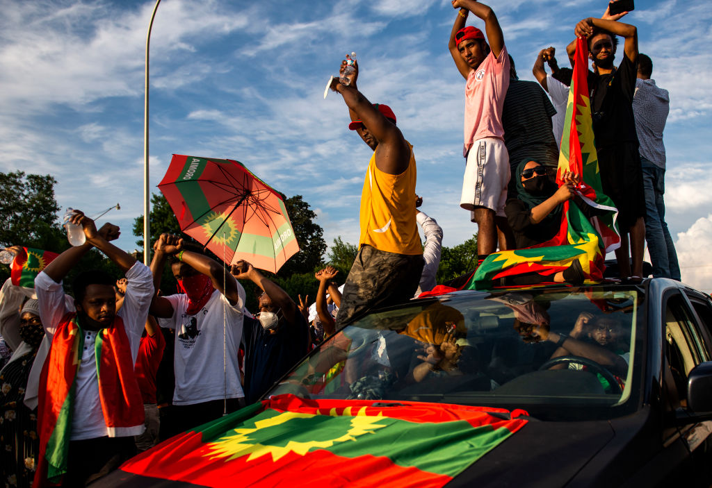 Demonstrators hold up a crossed-arms gesture during a protest after the death of musician and activist Hachalu Hundessa on the westbound lane of Interstate 94 on July 1, 2020 in St Paul, Minnesota. Hundessa was shot and killed in Addis Ababa, Ethiopia on June 29, which has sparked ongoing protests across the globe. (Stephen Maturen—Getty Images)