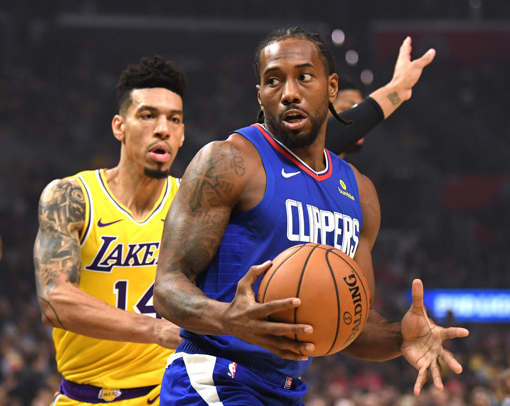 Kawhi Leonard #2 of the LA Clippers spins for a shot in front of Danny Green #14 of the Los Angeles Lakers during a 112-102 Clipper win in the LA Clippers season home opener at Staples Center on October 22, 2019 in Los Angeles, California. (Harry How—Getty Images)