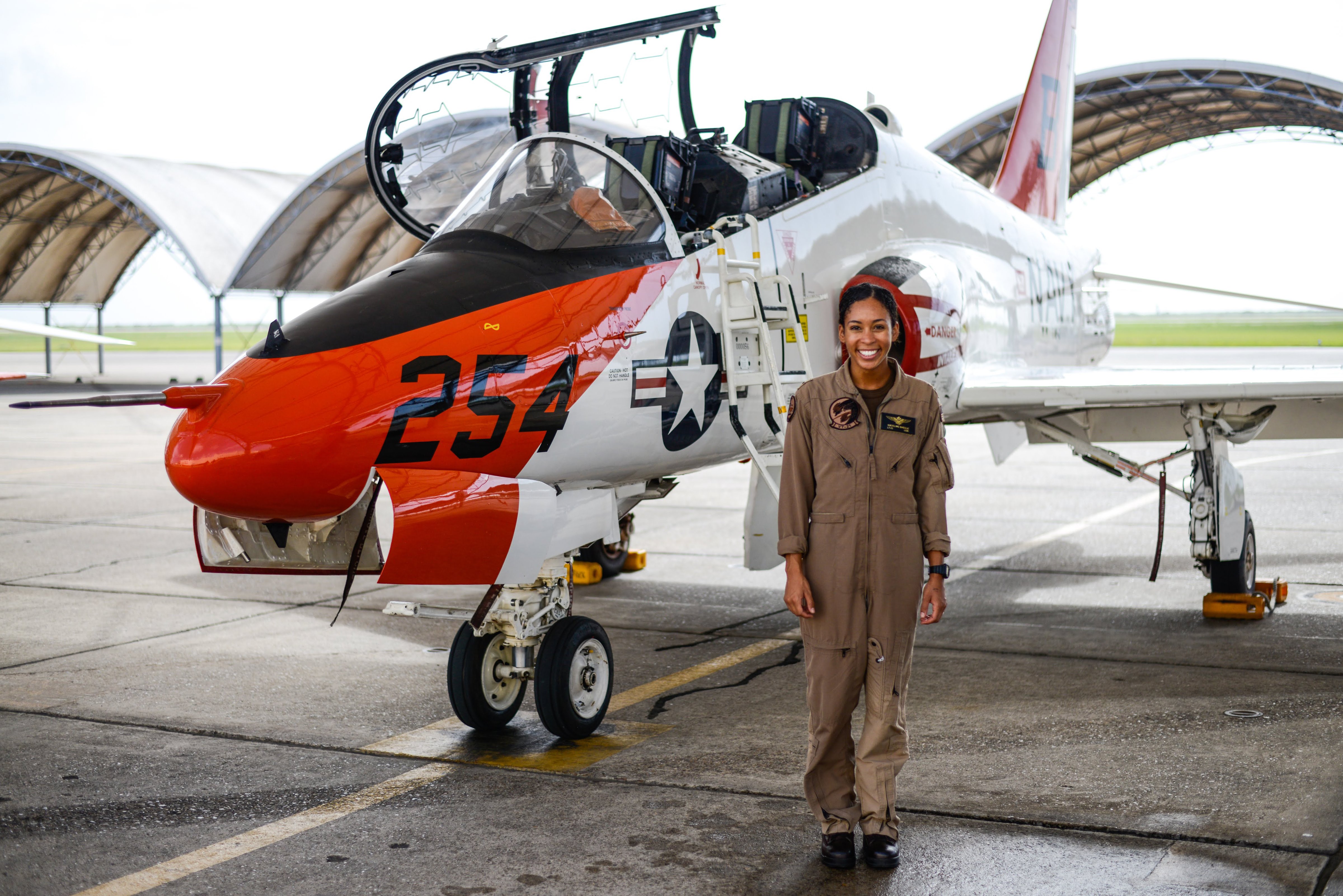 Student Naval Aviator Lt. j.g. Madeline Swegle, assigned to the Redhawks of Training Squadron (VT) 21 stands by a T-45C Goshawk training aircraft following her final flight to complete the undergraduate Tactical Air (Strike) pilot training syllabus, at Naval Air Station Kingsville, Texas, on July 7, 2020. (U.S. Navy photo by Lt.j.g. Luke Redito/Released)
