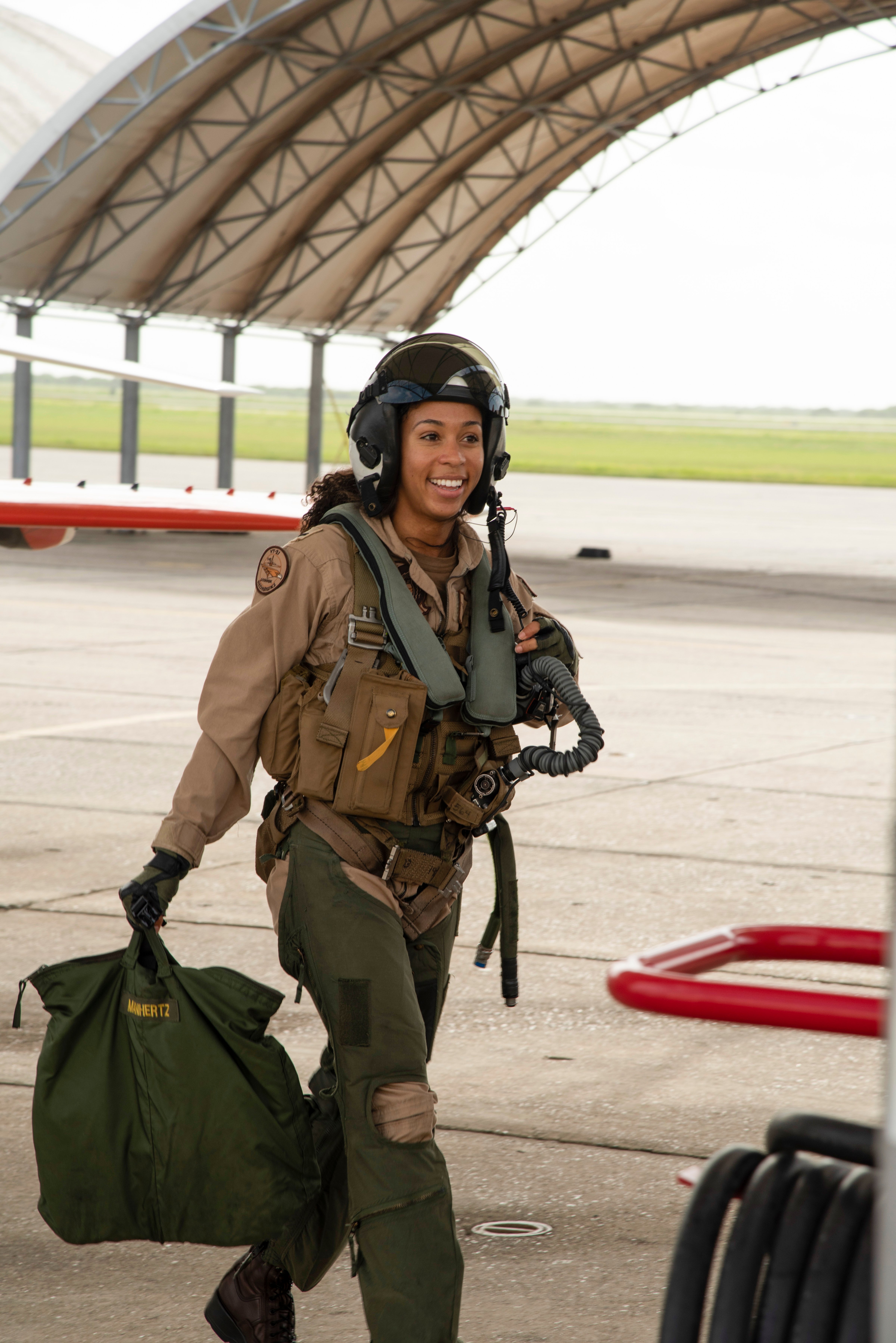 Student Naval Aviator Lt. j.g. Madeline Swegle, assigned to the Redhawks of Training Squadron (VT) 21 at Naval Air Station Kingsville, Texas, exits a T-45C Goshawk training aircraft following her final flight to complete the undergraduate Tactical Air (Strike) pilot training syllabus, July 7. Swegle is the U.S. Navy's first known Black female strike aviator and will receive her Wings of Gold during a ceremony July 31. (U.S. Navy photo by Anne Owens/Released)