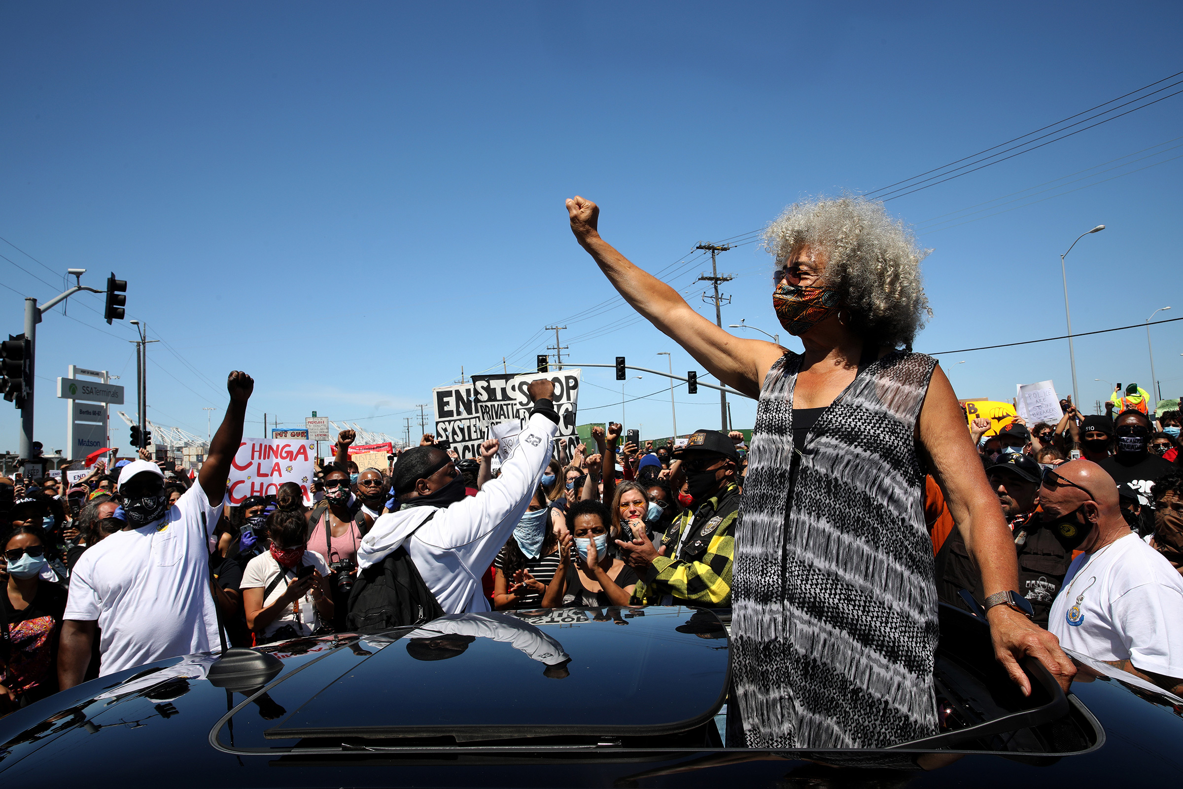 Civil rights leader Angela Davis raises her fist during a Juneteenth protest against police brutality in Oakland, Calif., on June 19, 2020. (Yalonda M. James—The San Francisco Chronicle/Getty Images)