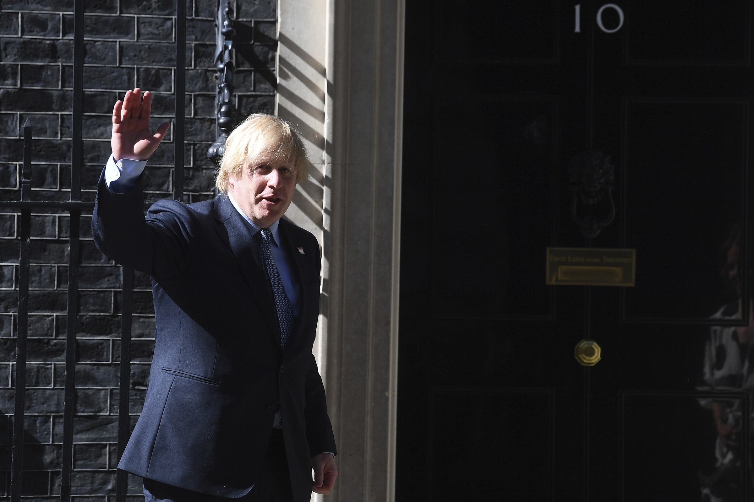 Prime Minister, Boris Johnson joins in the pause for applause to salute the NHS in London on July 5, 2020. (Press Association via AP)