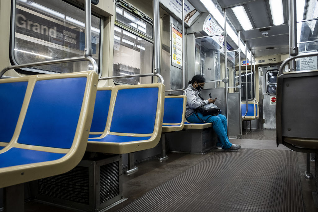A commuter wearing a protective mask looks at a mobile device while riding a Chicago Transit Authority (CTA) train in Chicago, Illinois, U.S., on Wednesday, June 3, 2020. (Christopher Dilts—Bloomberg/Getty Images)