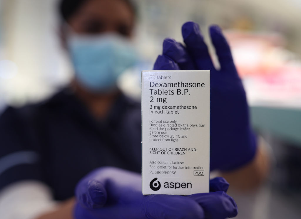 A pharmacy staff member holds dexamethasone tablets in London on June 18, 2020. (Yui Mok/PA Images—Getty Images)