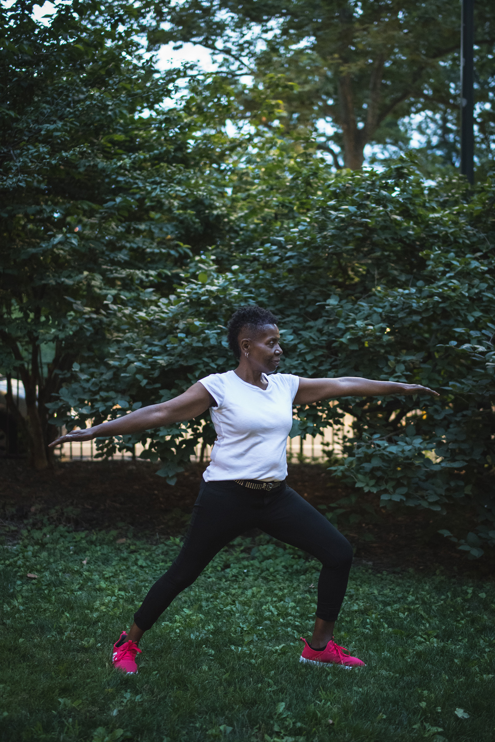 Woodson holds a yoga warrior pose in Central Park on July 16
