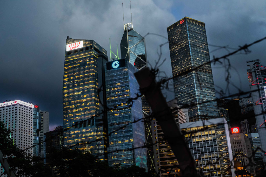 A barbed-wire fence stands near buildings illuminated at dusk in the Central district in Hong Kong, China, on Monday, June 22, 2020. (Billy H.C. Kwok–Bloomberg/Getty Images)
