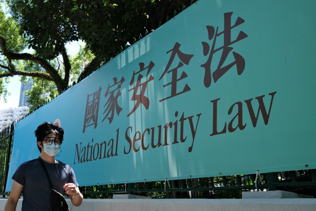 A man walks past a public notice banner for the National Security Law in Hong Kong on July 15, 2020. (ANTHONY WALLACE—AFP/Getty Images)