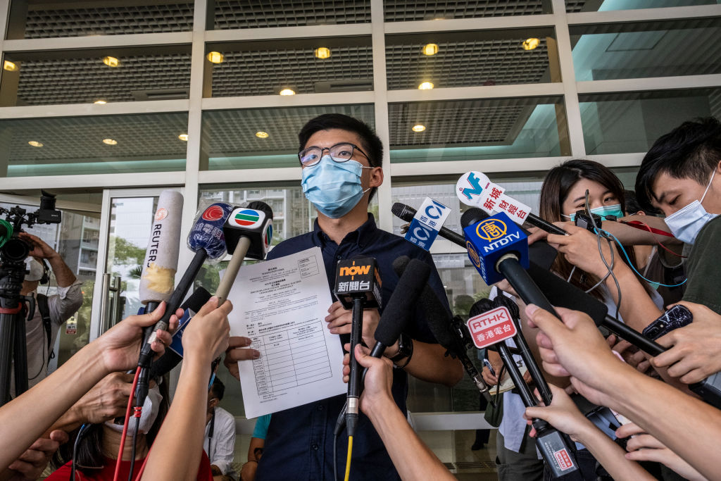 Joshua Wong holds his application for his run in the 2020 Legislative Council Election during a press conference in Hong Kong on July 20, 2020. (Vernon Yuen—NurPhoto/Getty Images)