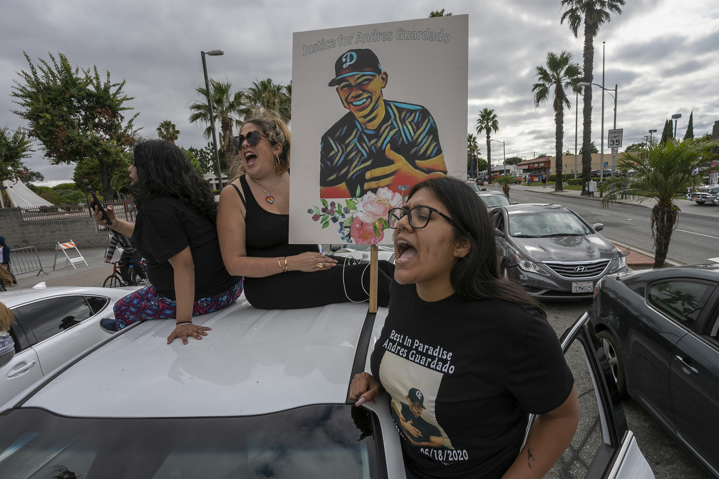 A woman holds a placard as activists and relatives of Andres Guardado, who was shot and killed by a sheriff's deputy in Gardena, rally to call on the city to rescind its policing contract, in Compton, California, on June 28, 2020. (David McNew—AFP via Getty Images)