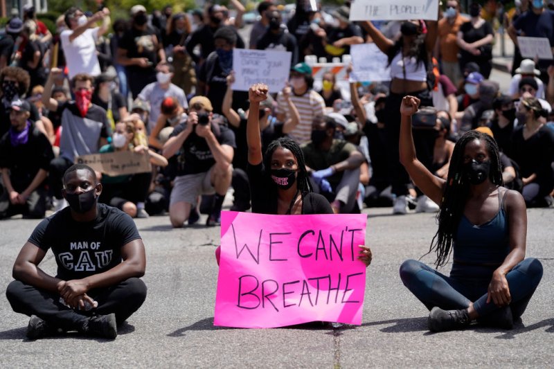 Protesters sit at an intersection in West Hollywood during demonstrations in Los Angeles, Calif. on May 30, 2020.