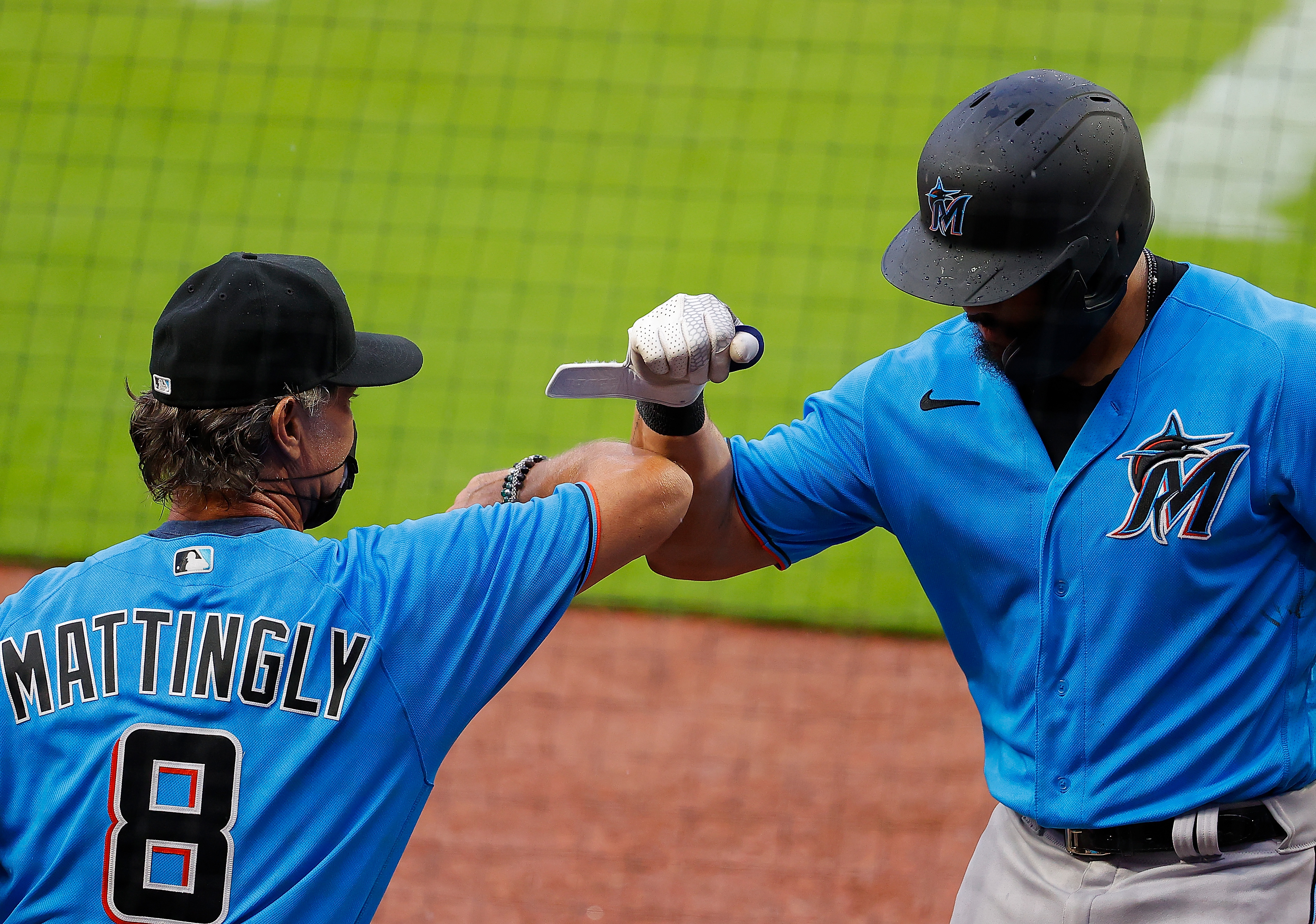 Jorge Alfaro #38 of the Miami Marlins reacts with manager Don Mattingly #8 after hitting a solo homer in the third inning against the Atlanta Braves during an exhibition game at Truist Park on July 21, 2020 in Atlanta, Georgia. (Kevin C. Cox—Getty Images)