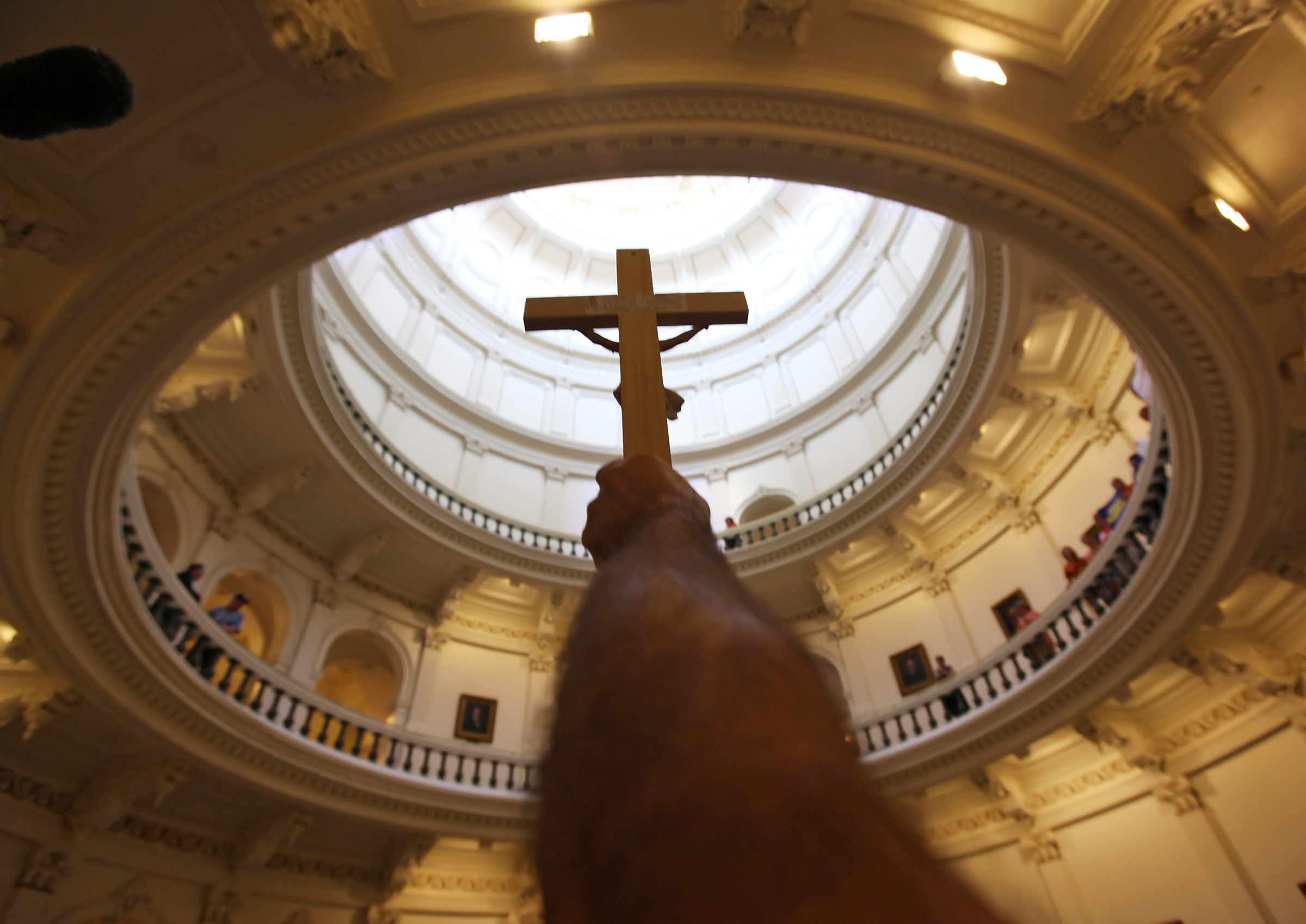 A pro-life supporter holds up a crucifix at the Texas State capitol on Jul. 1, 2013 in Austin (Erich Schlegel—Getty Images)