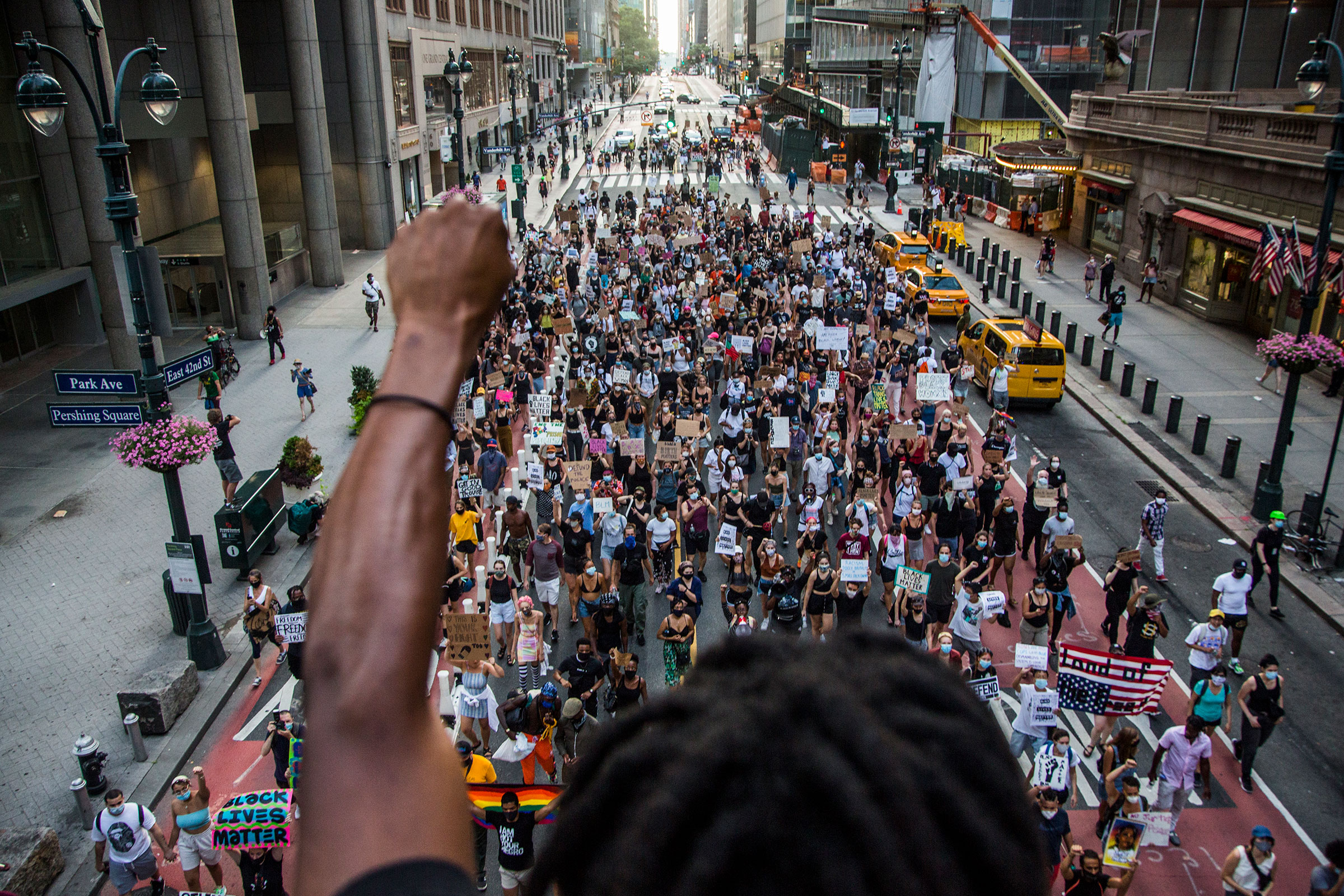 A man raises his arm in support of the crowd of protesters marching in downtown New York, NY on July 26, 2020. (Pablo Monsalve—VIEWpress/Getty Images)