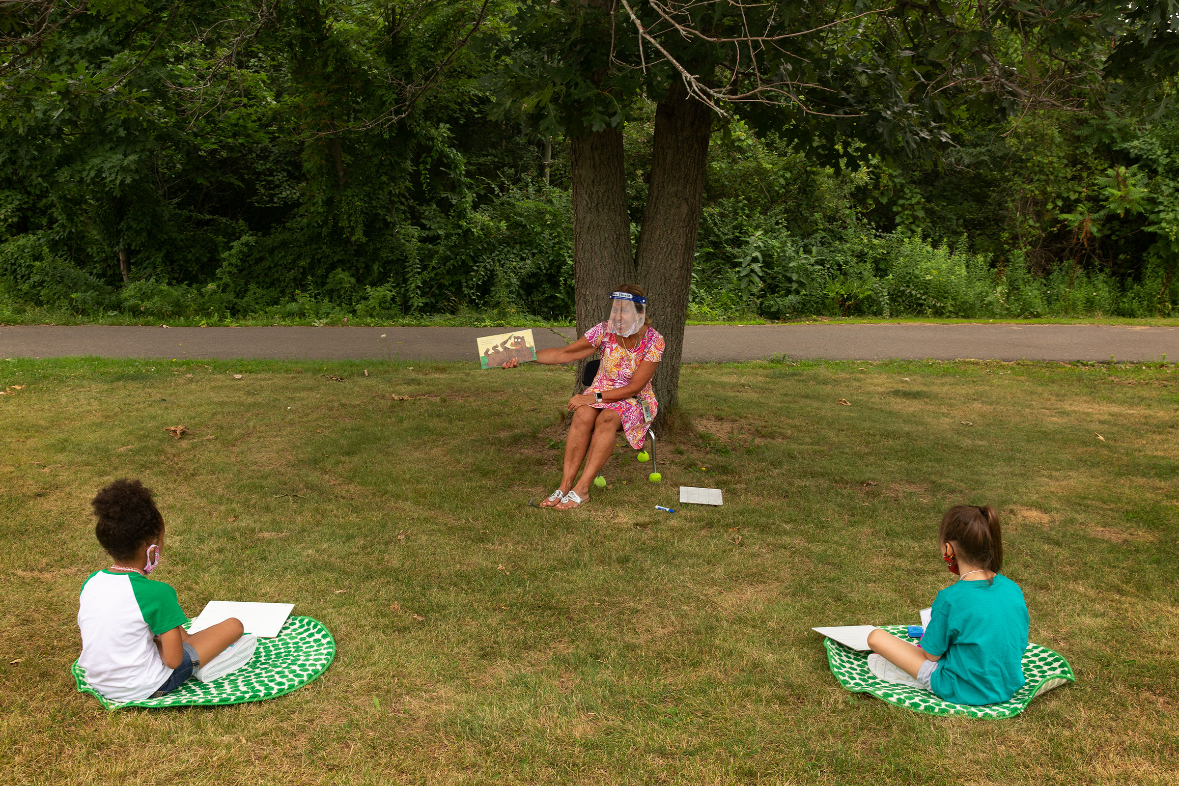 Teacher Judy David reads to first-graders. When possible, some lessons are held outside (Gillian Laub for TIME)