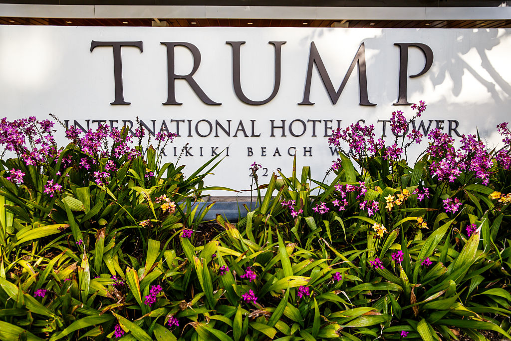 Tropical flowers and front entrance sign of Trump International Hotel Waikiki Beach. Five Star luxury hotel &amp; residences owned by Donald Trump (Julie Thurston Photography/Getty Images)